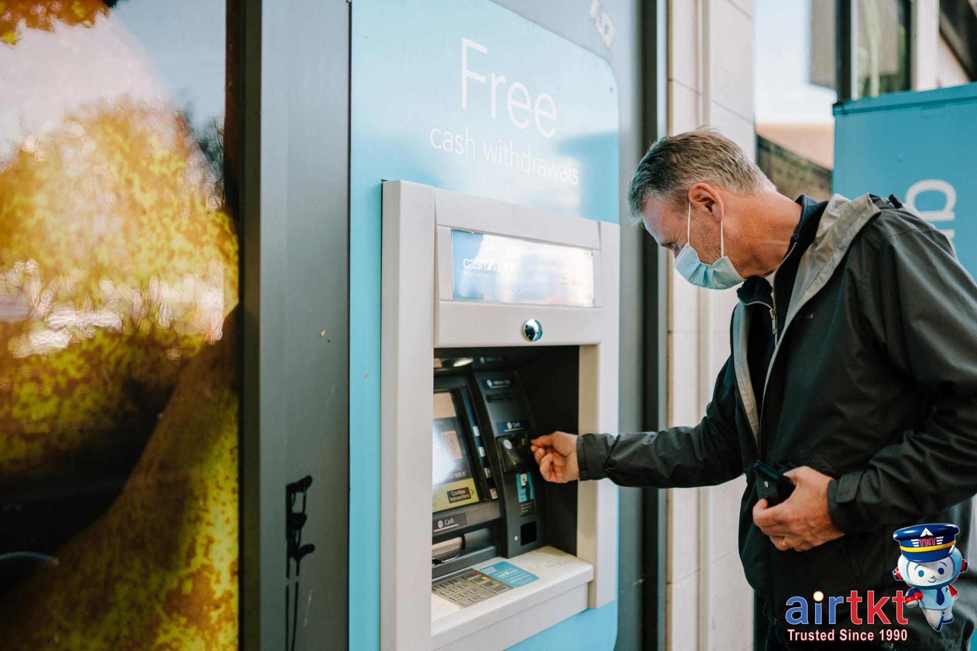 Traveler calling their bank after discovering ATM skimmer device in city street
