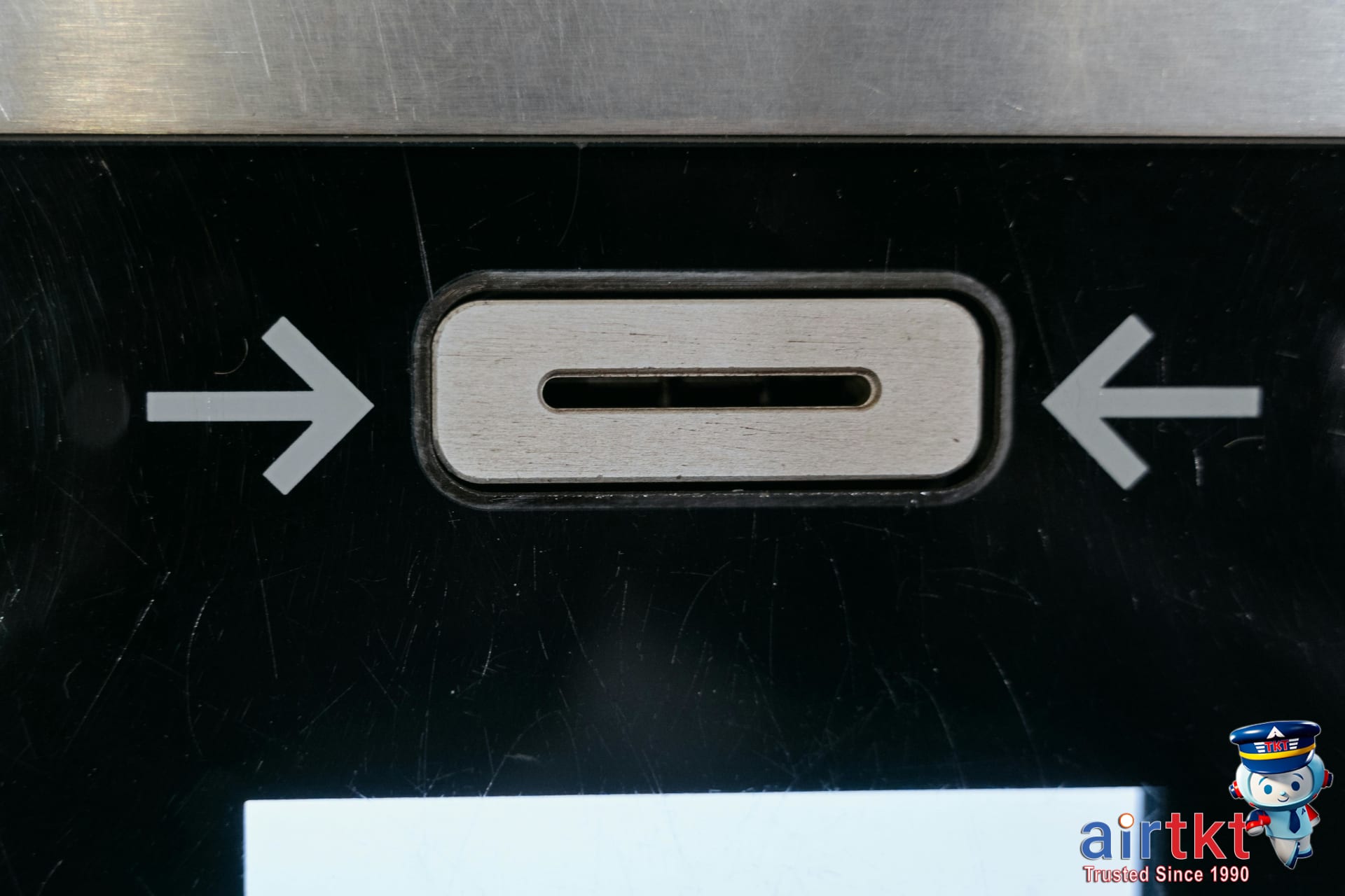 Traveler using ATM abroad cautiously at secure and well-lit location