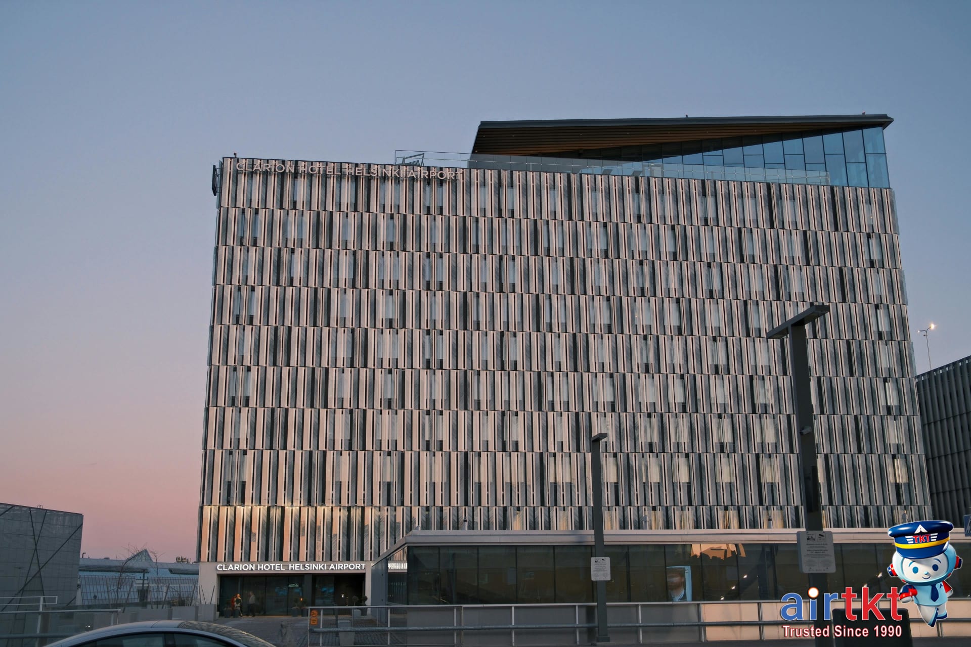 Budget tiers for airport and downtown hotels shown with hotel building facade.
