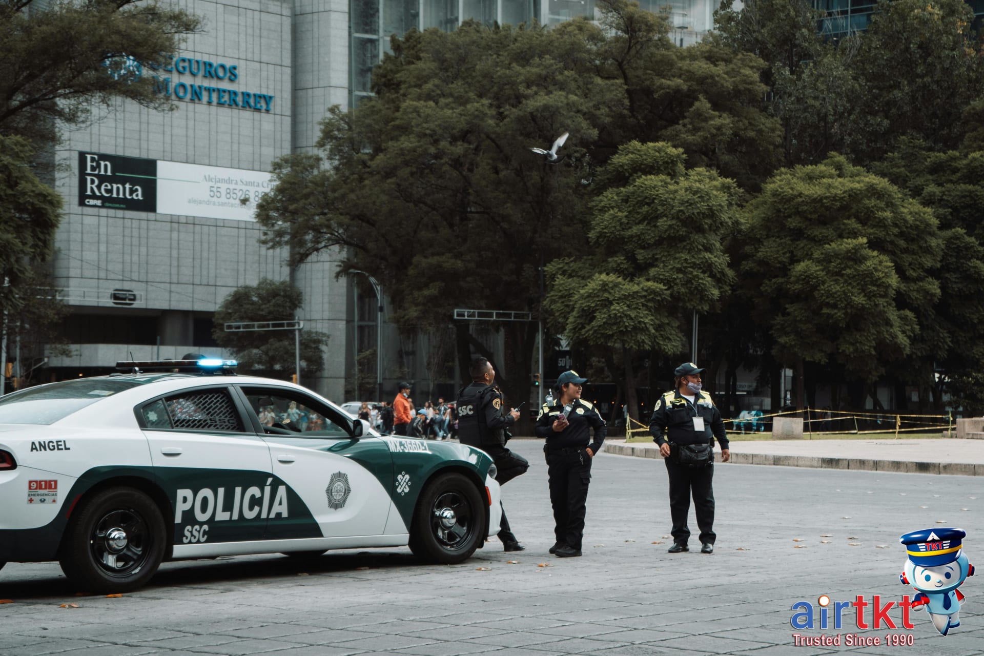 Mexico City police officers patrolling urban area near tourists in CDMX historic district