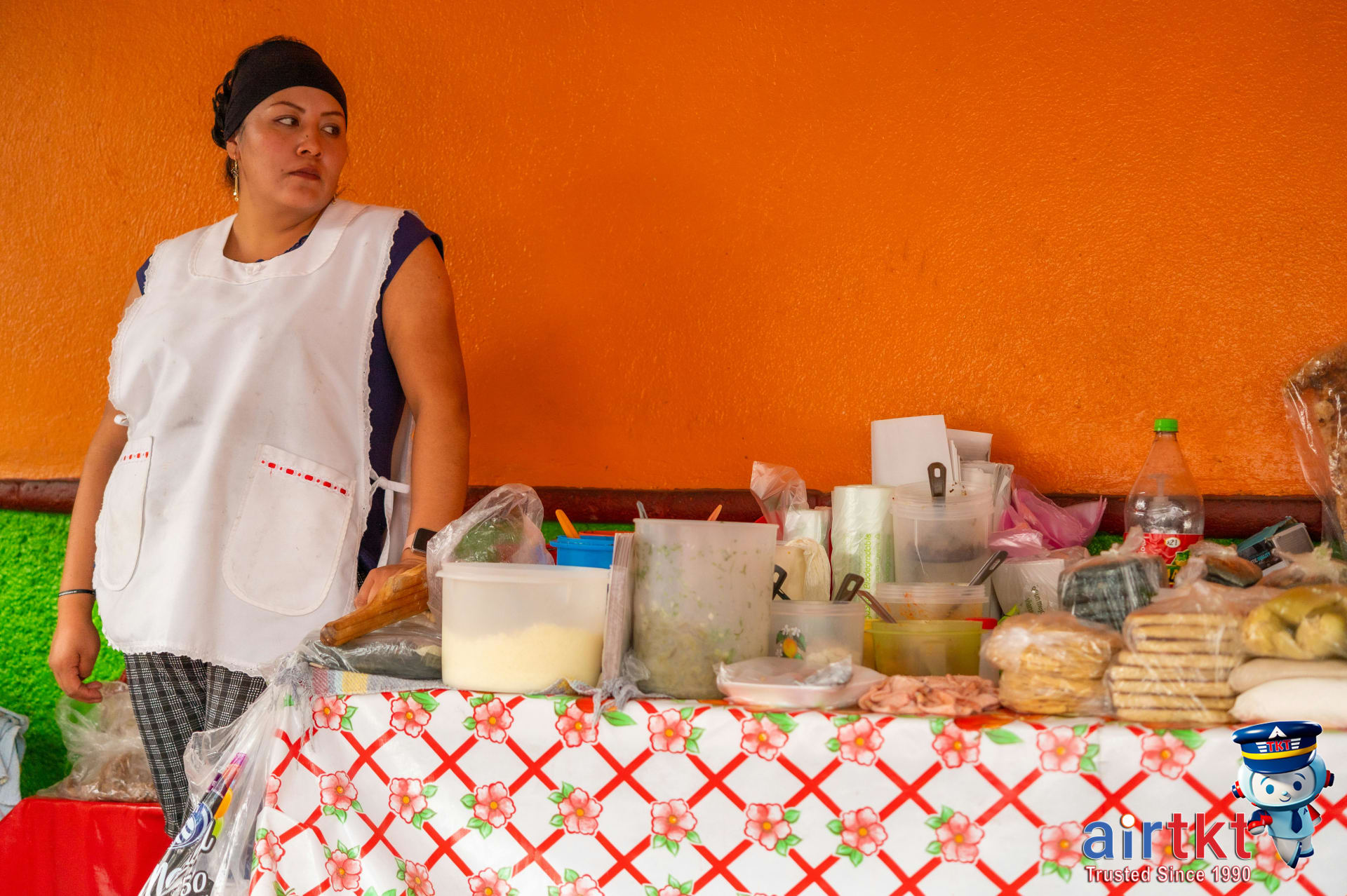 Street vendor selling Mexican dishes at colorful Mexico City market
