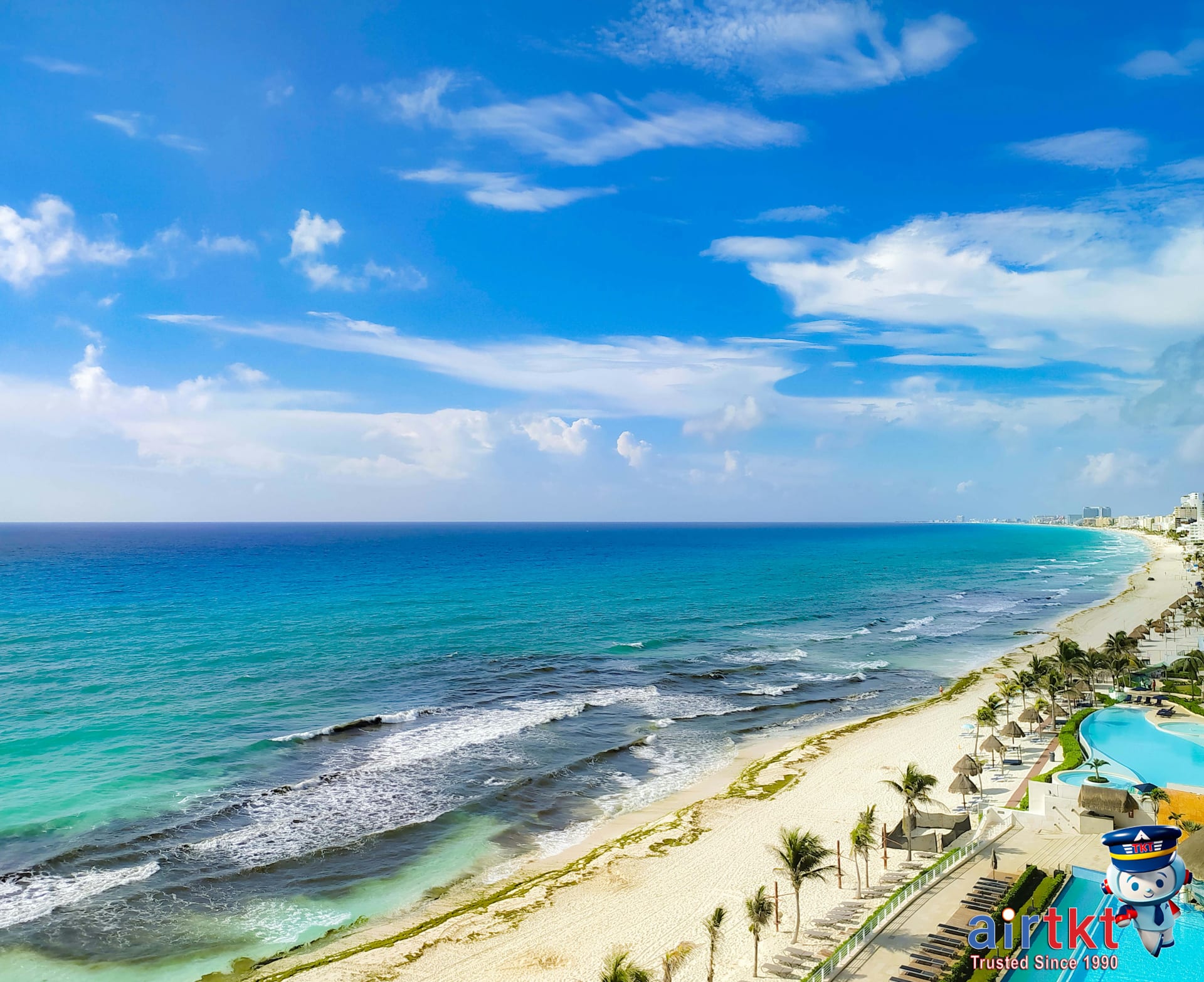 Panoramic view of Cancun beach with turquoise waters and palm trees