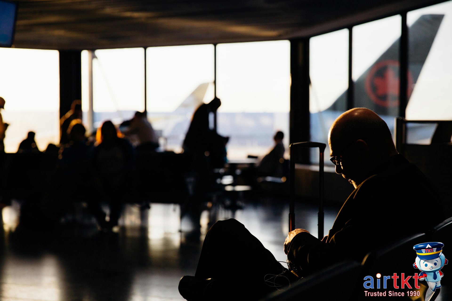 Traveler resting with eye mask on plane managing jet lag symptoms