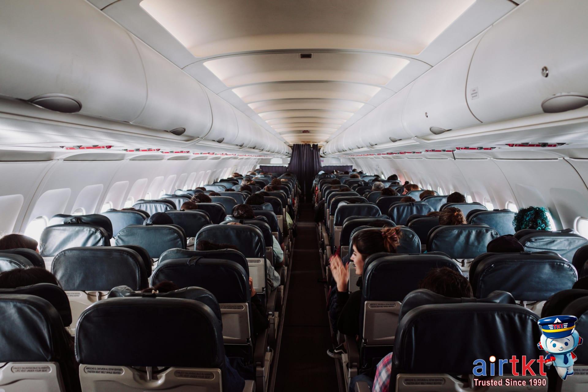 Passenger stretching in airplane aisle for long haul flight wellness