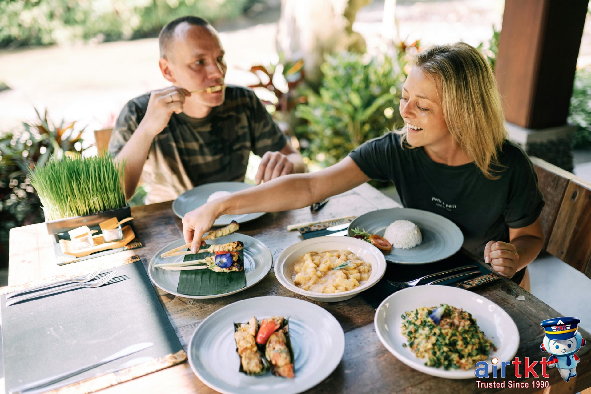 Travelers enjoying fresh healthy meals safely at outdoor table for food safety