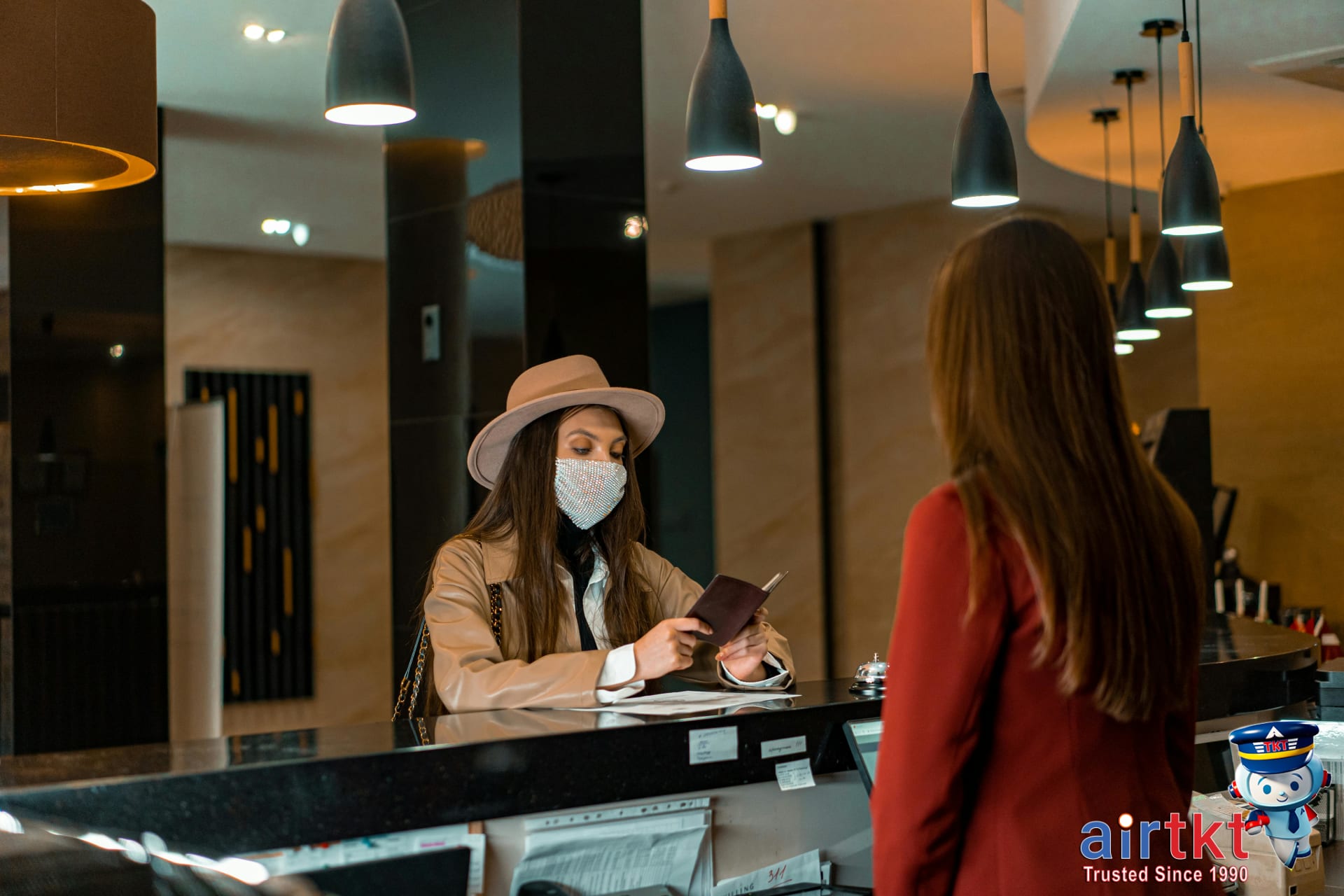 Negotiating hotel room rates and upgrades with hotel staff at the check-in counter
