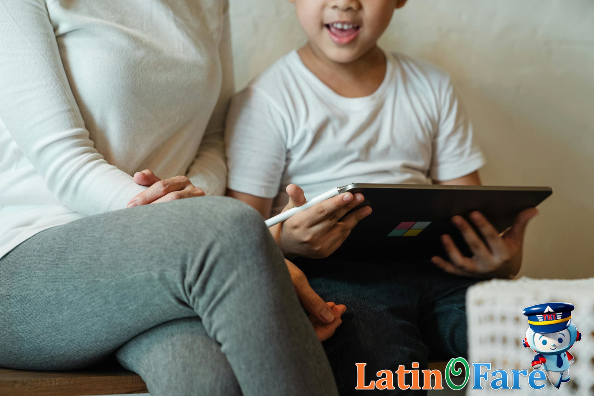 Parent handing a tablet to child to keep entertained during family flights with kids’ snacks ready.