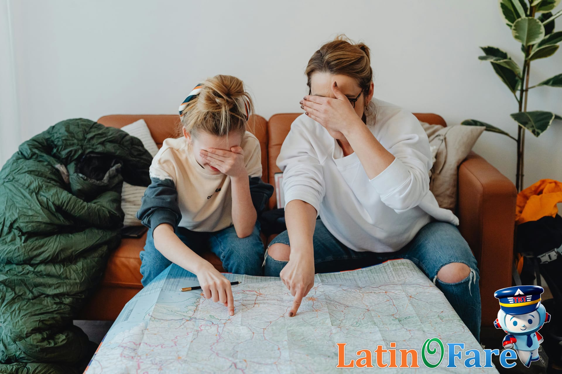 Family planning vacation together with kids reviewing a travel map on couch, highlighting challenges of family travel