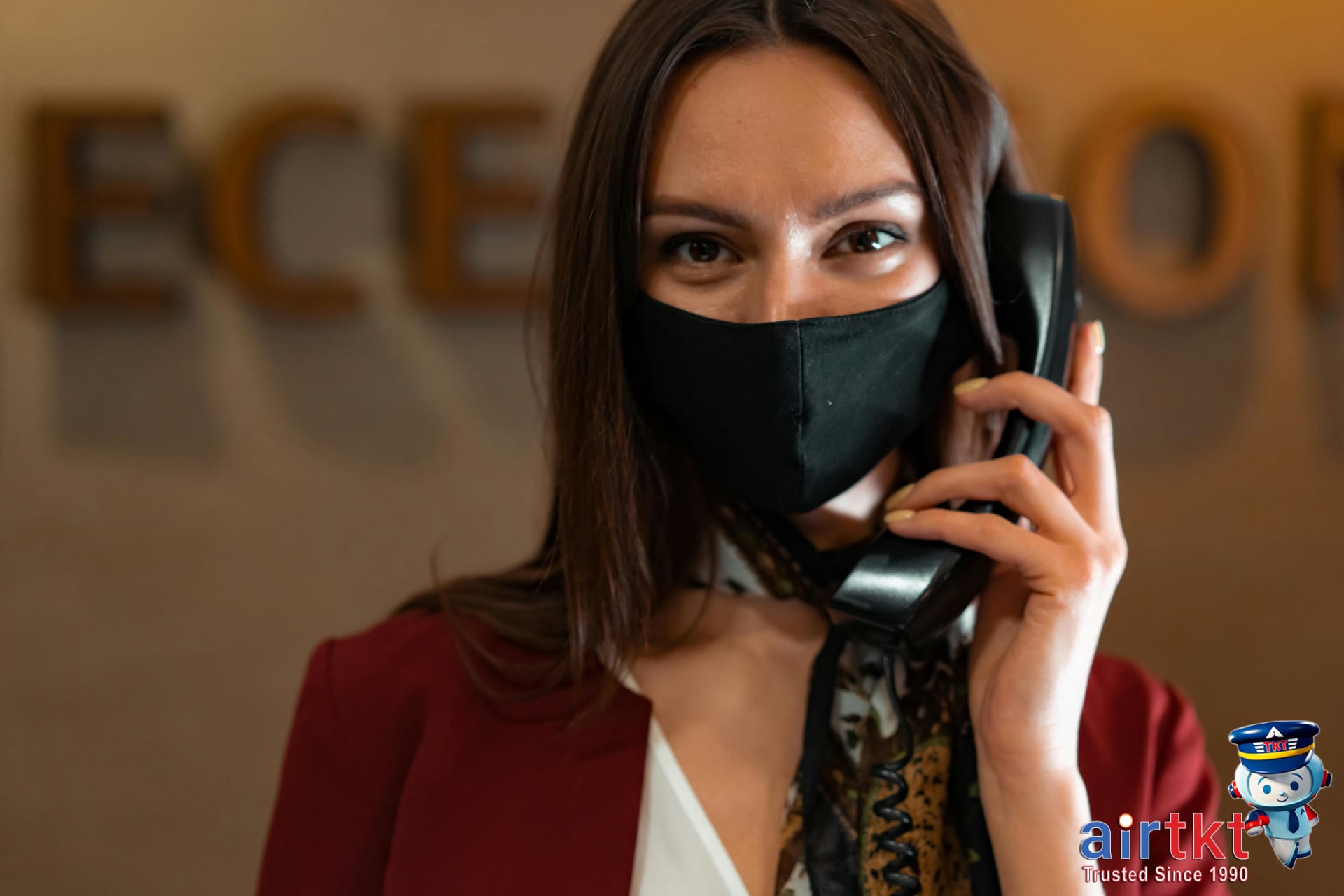 Hotel receptionist assisting guest on phone about cancellation fee questions