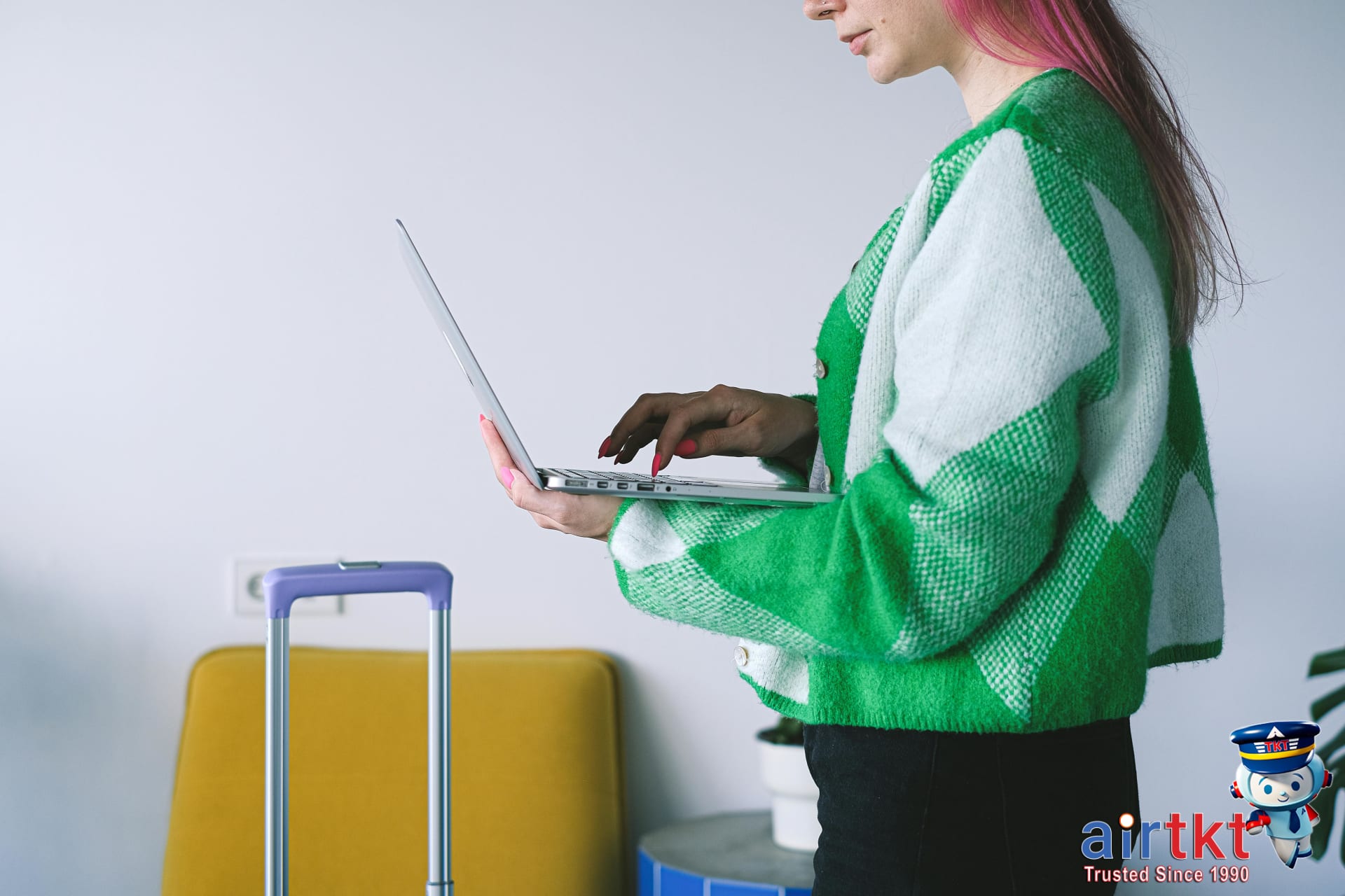 Woman reviewing hotel booking options on laptop showing non-refundable rate choices