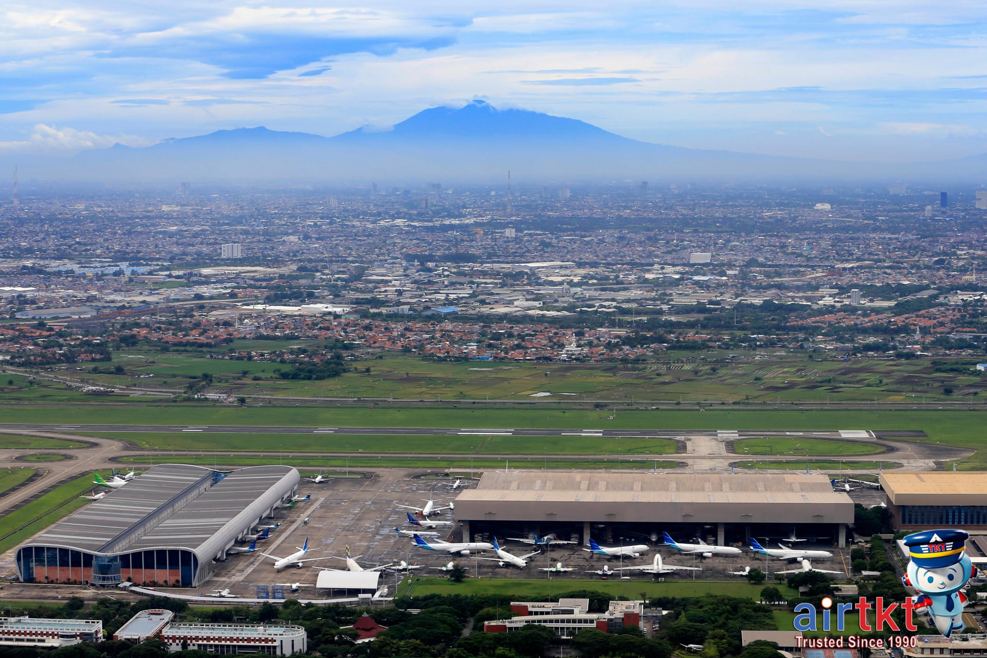 Aerial city view showcasing multiple nearby airports with planes in flight