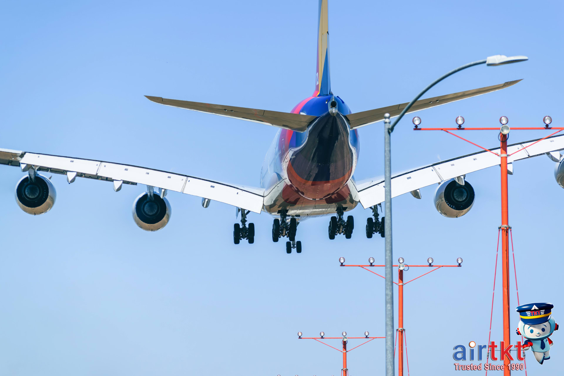 Airplane landing at small airport runway with clear sky in daytime