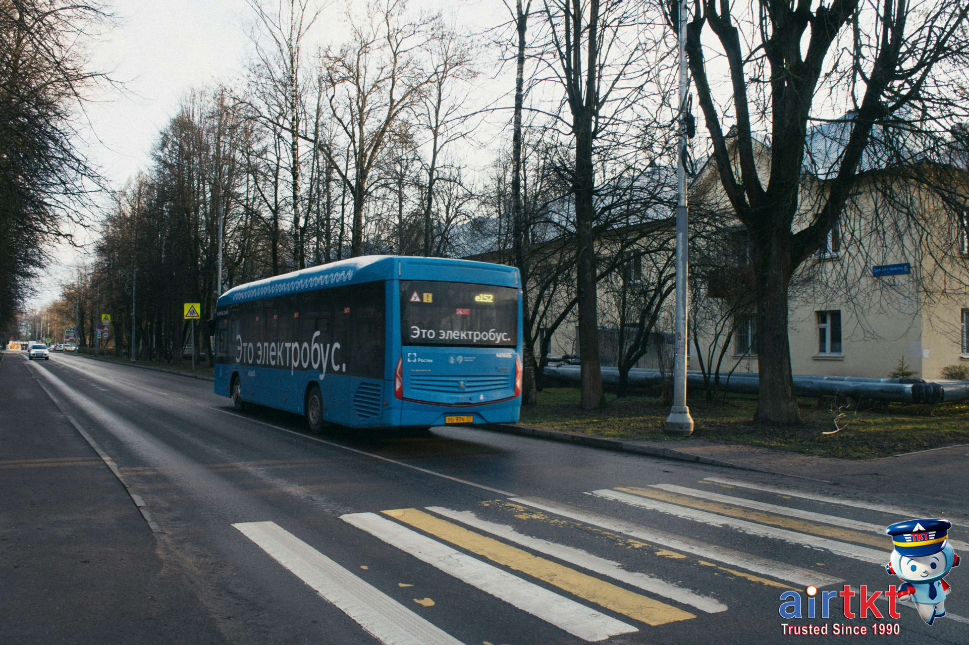 Environmentally friendly electric bus operating in city during winter snow