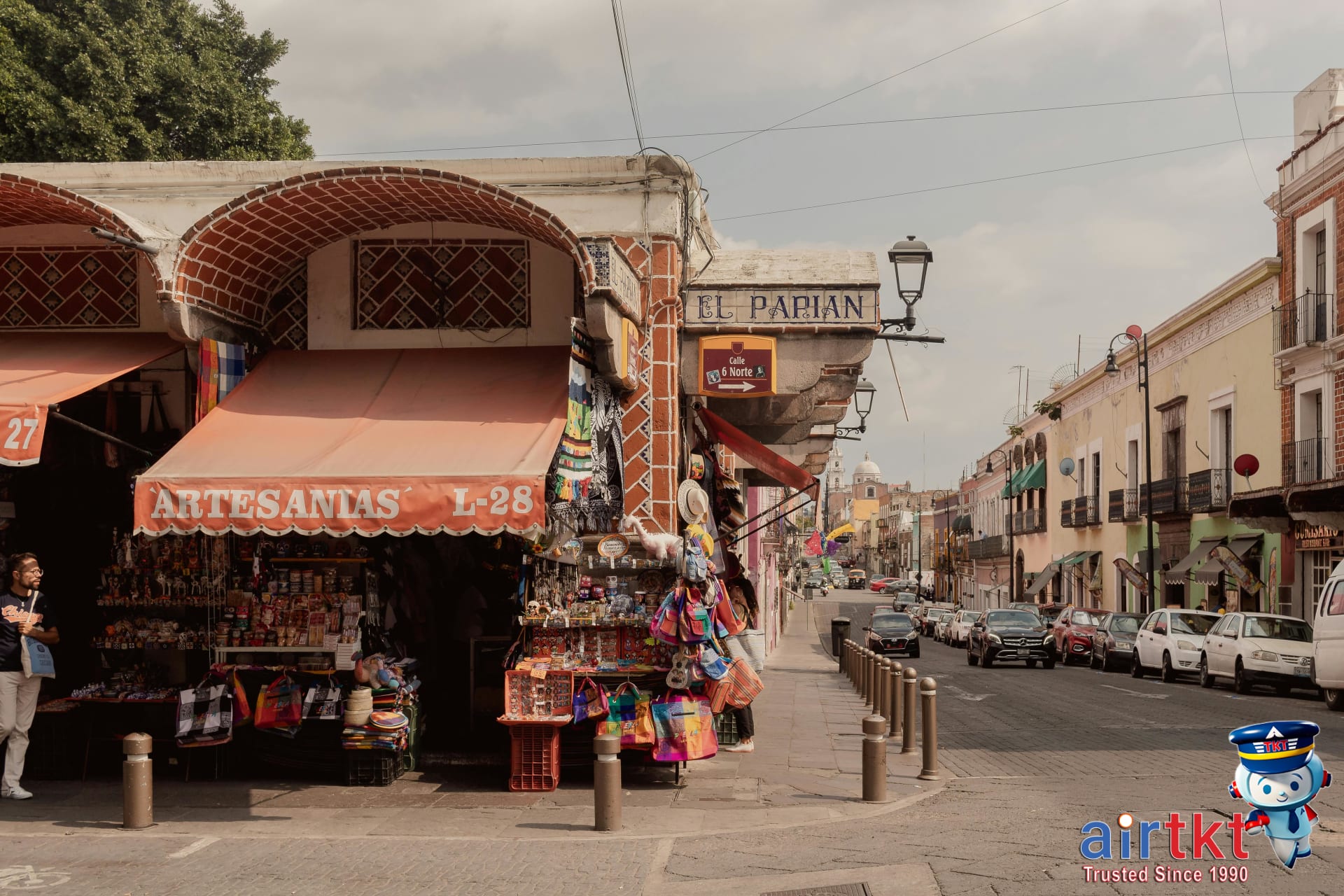 Busy market street with Mexican crafts and souvenirs during Cinco de Mayo in Puebla