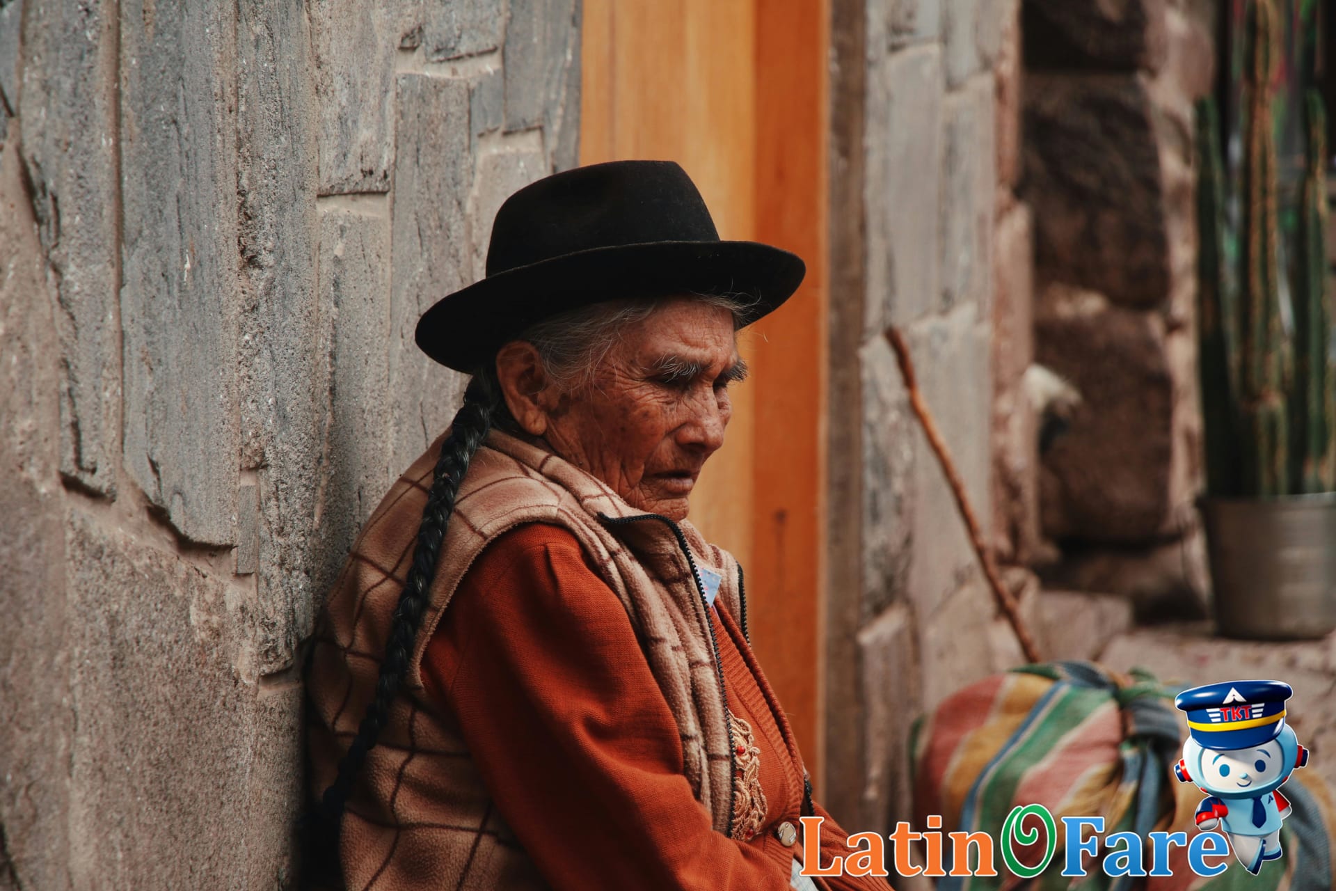Elderly Peruvian woman selling traditional crafts at lively Aguas Calientes market near Machu Picchu
