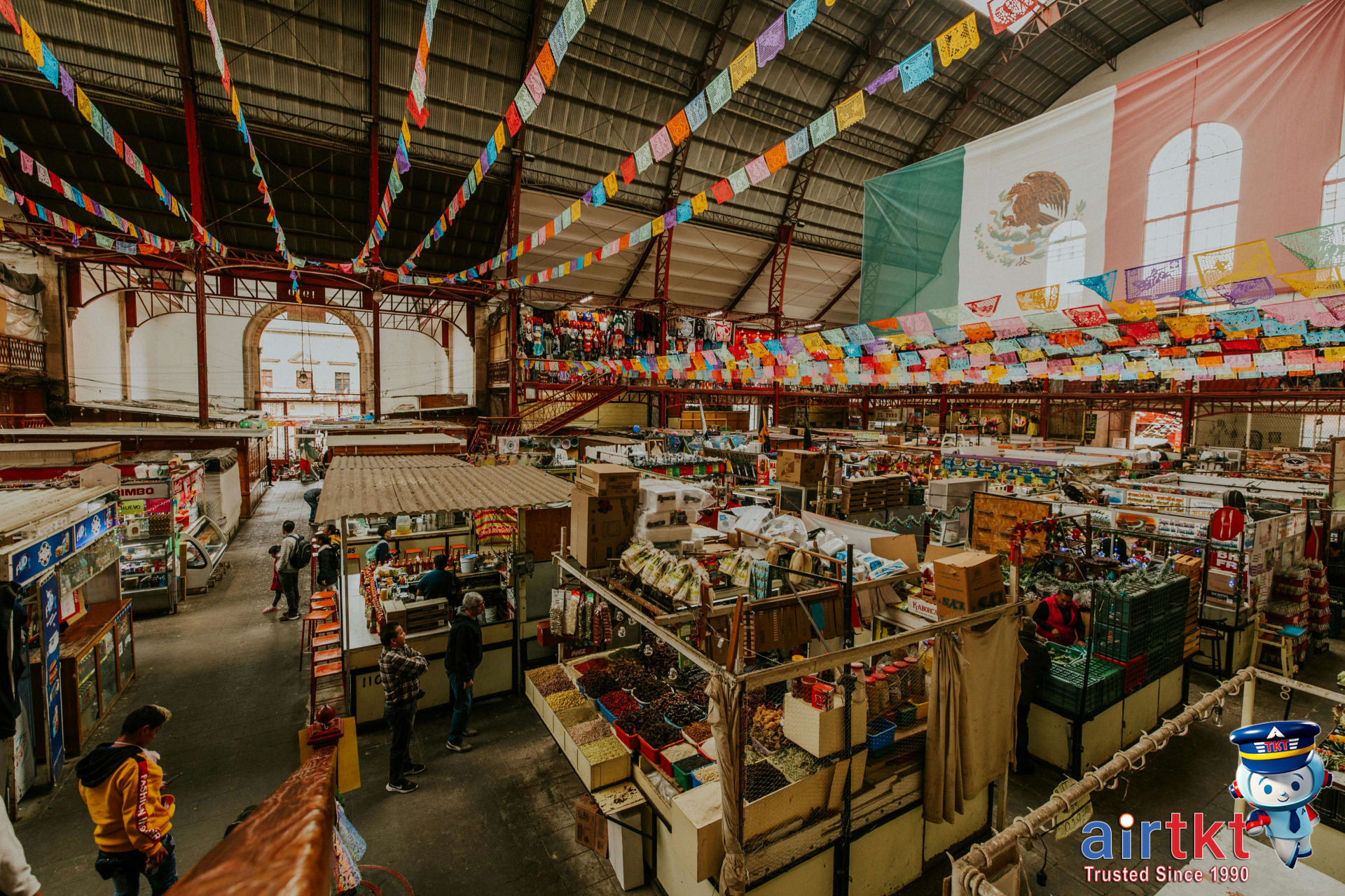 Food stalls inside Mercado San Juan de Dios with colorful local Mexican cuisine