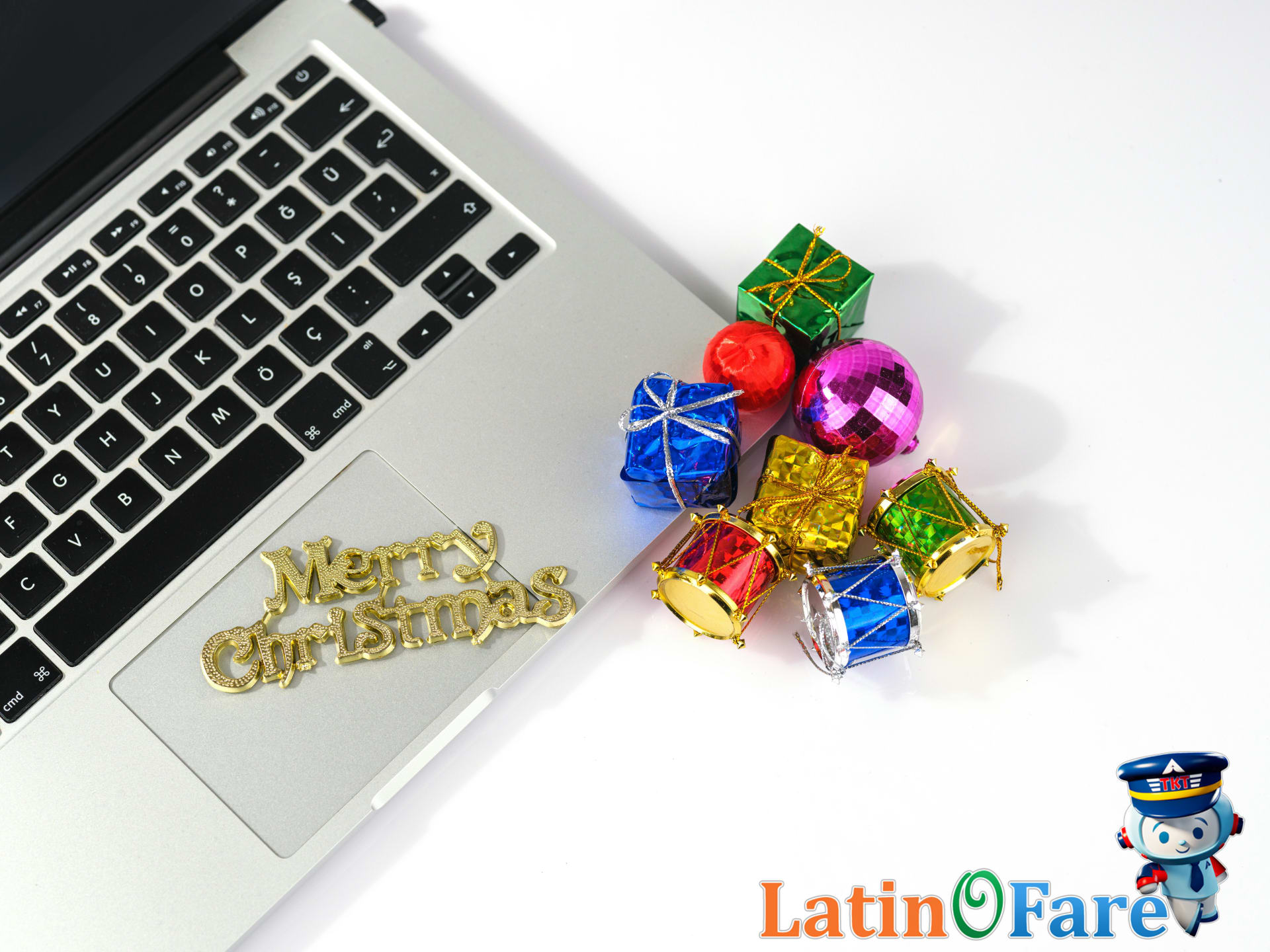 Booking Christmas travel online with laptop and festive holiday decorations for the winter season