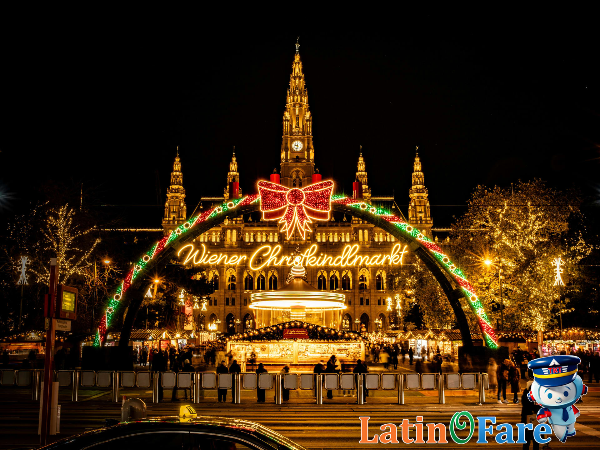Bustling Christmas market with glowing lights and festive stalls at night, perfect for travel