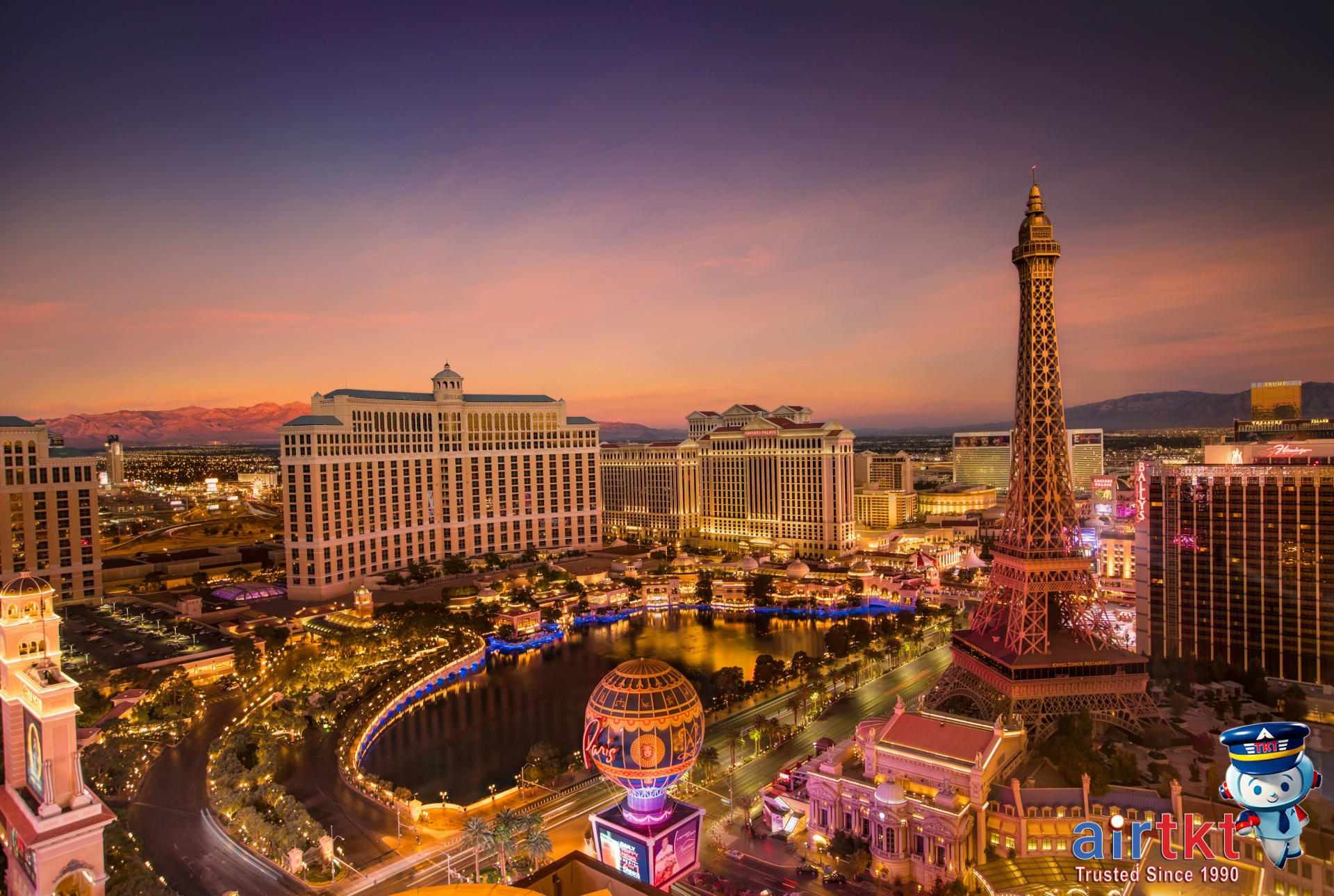 Las Vegas Strip skyline glowing at sunset with Eiffel Tower landmark