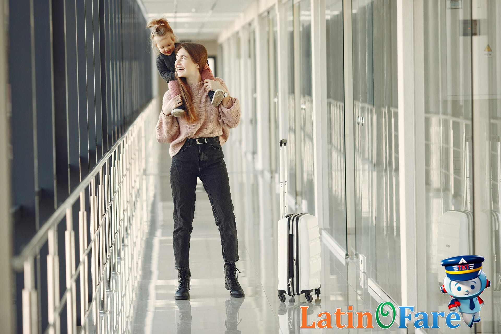 Mother and daughter walk together with suitcases in a sunny airport terminal during a fun family vacation.