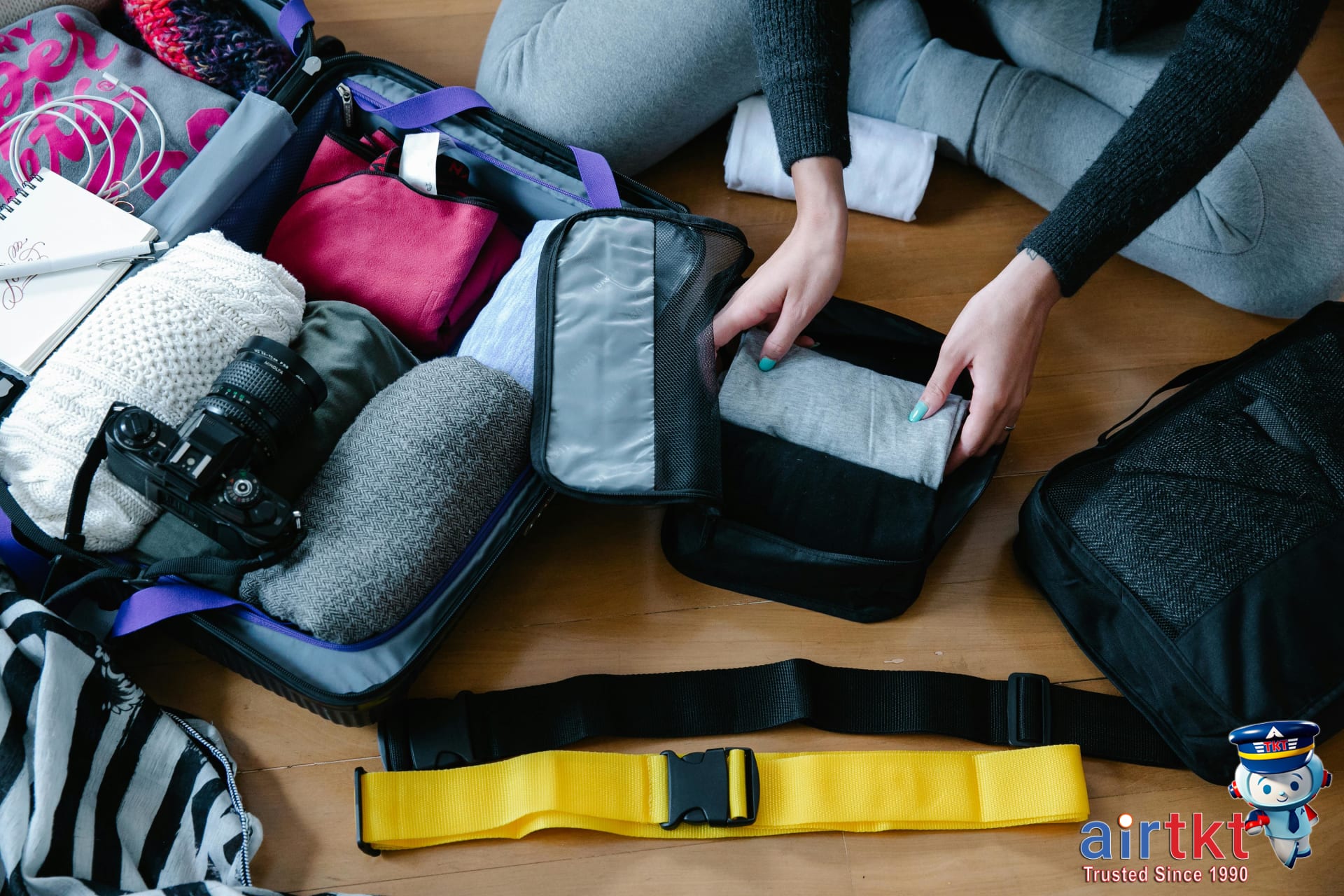 Packing cubes neatly arranged inside suitcase for travel FAQ