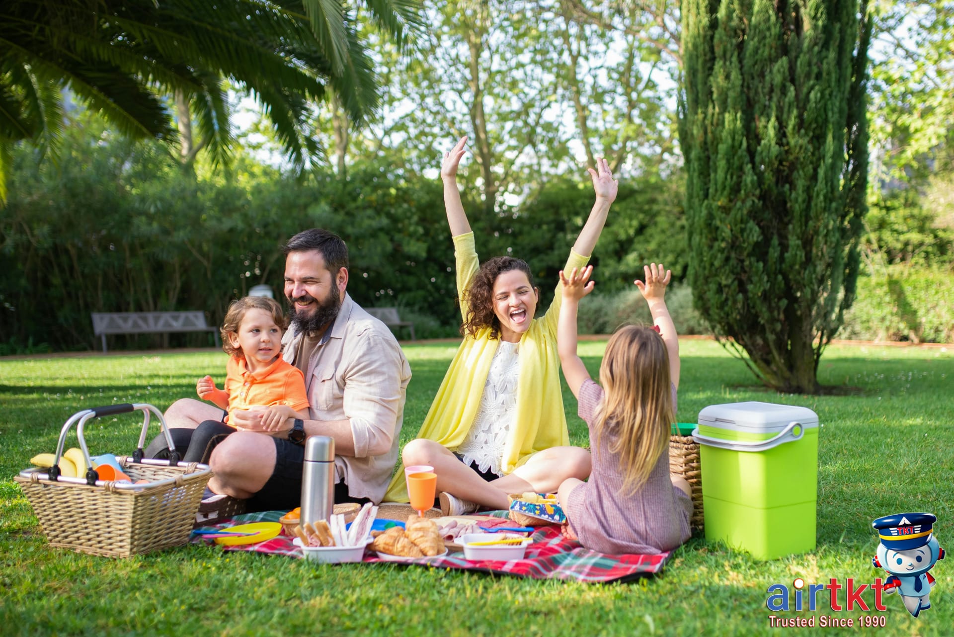 Family picnic in spring for Mother's Day weekend in blooming park setting
