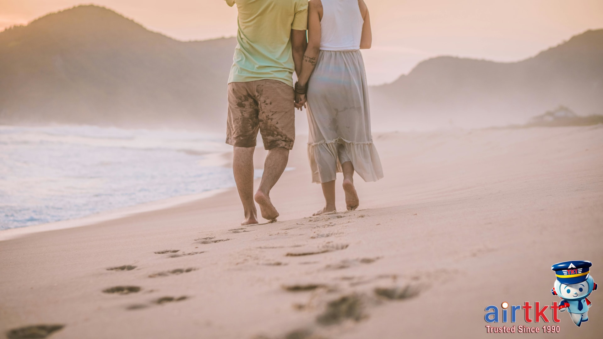 Romantic beach walk on Mother's Day weekend with couple holding hands in sunrise