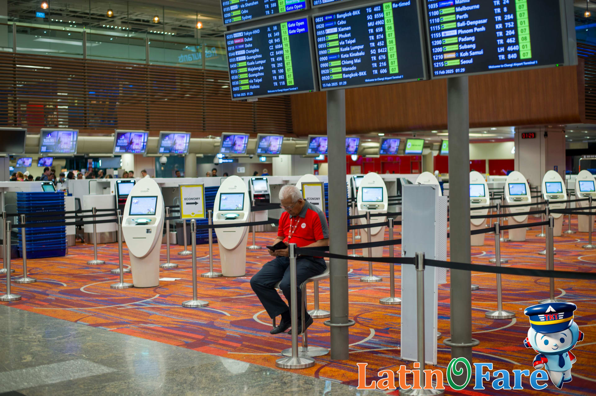 Traveler consulting airport FAQ board for up-to-date passenger rights regarding flight delays and airline compensation.