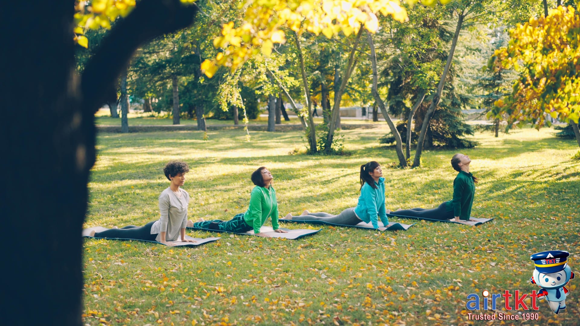 Outdoor yoga class in Denver park with participants and mountain views