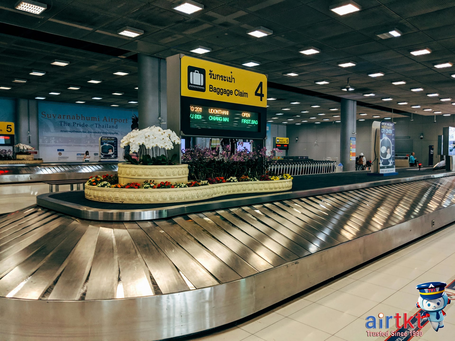 Luggage claim area where passengers retrieve bags from budget airline flights in Asia