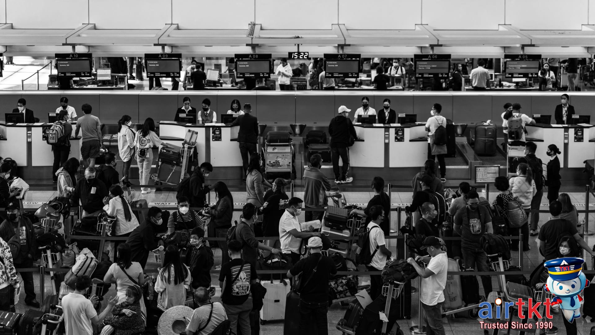 Budget airlines check-in area with travelers lining up at an Asian airport