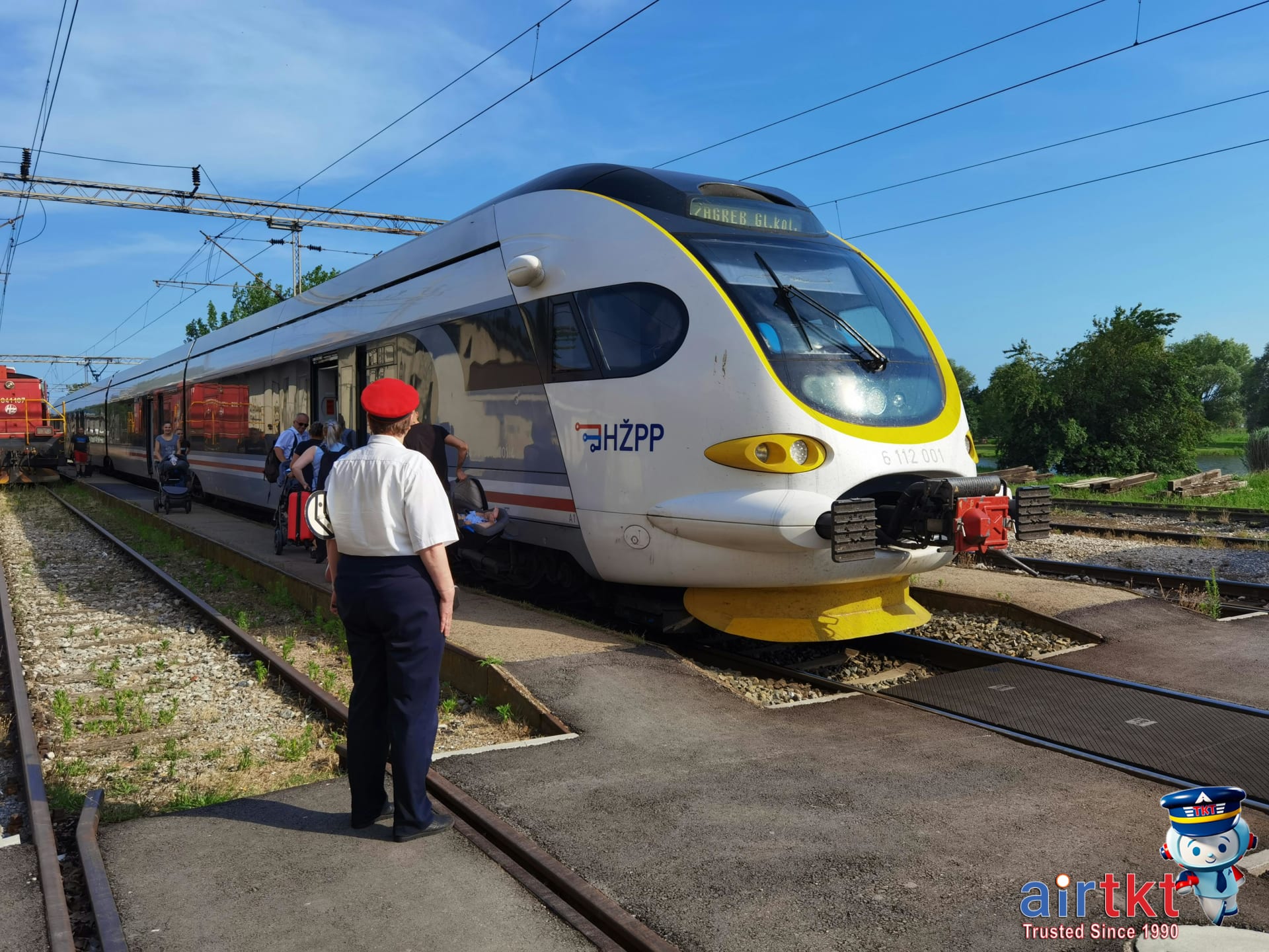 Amtrak conductor assisting passengers safely boarding train