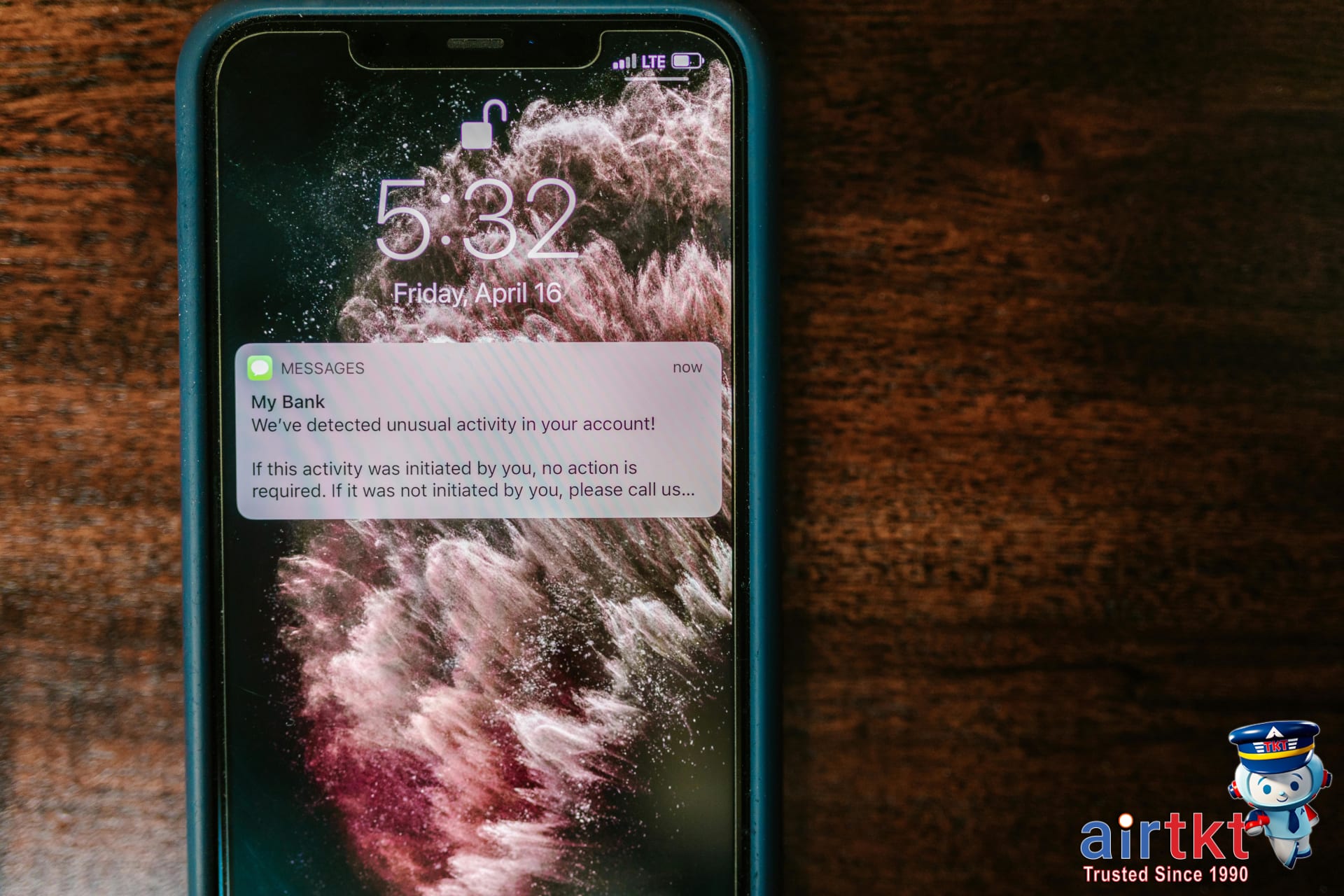 Mobile phone showing last-minute flight deal notification on wooden table