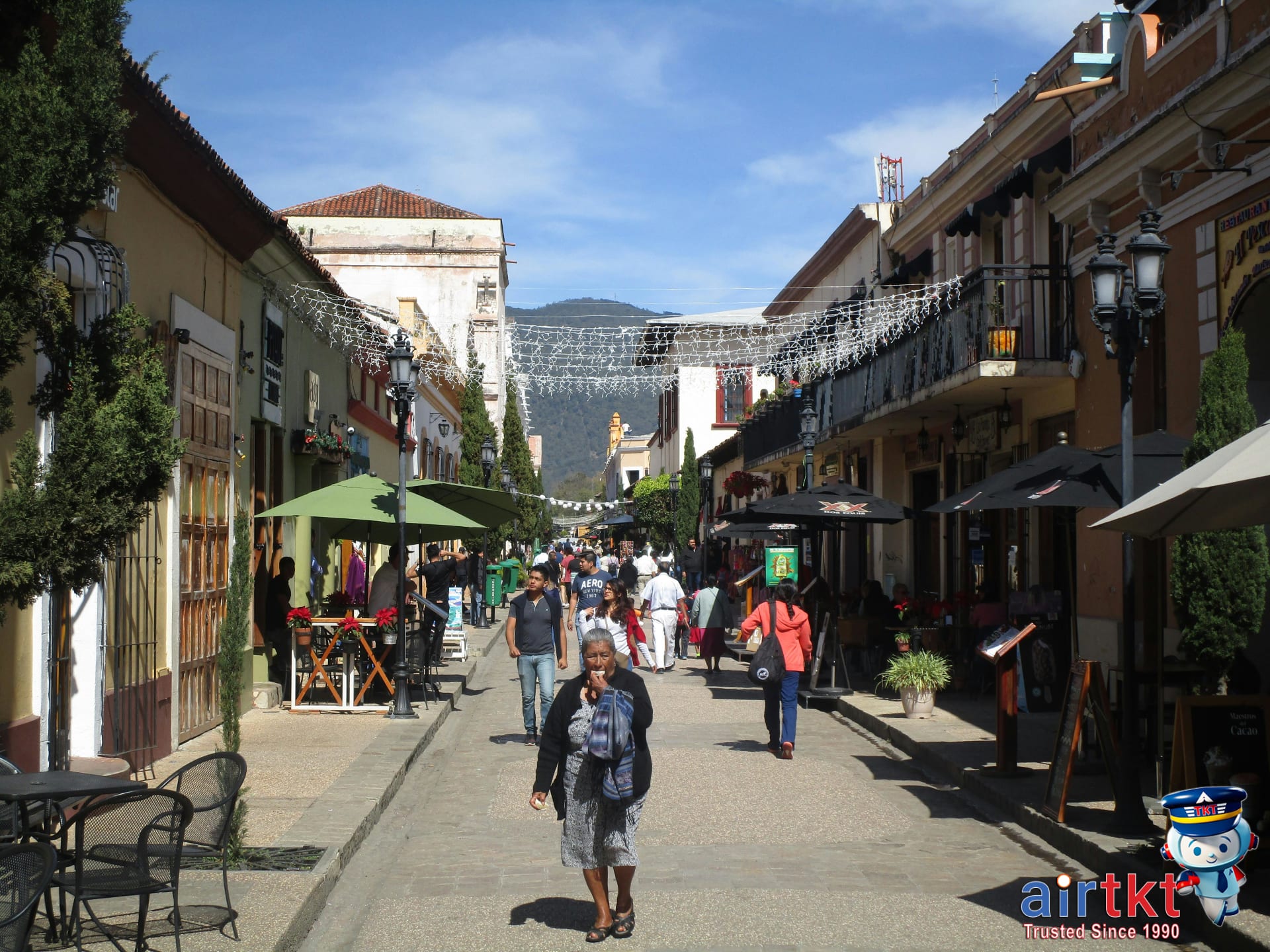 Bustling street market scene in San Cristóbal de las Casas under sunny skies