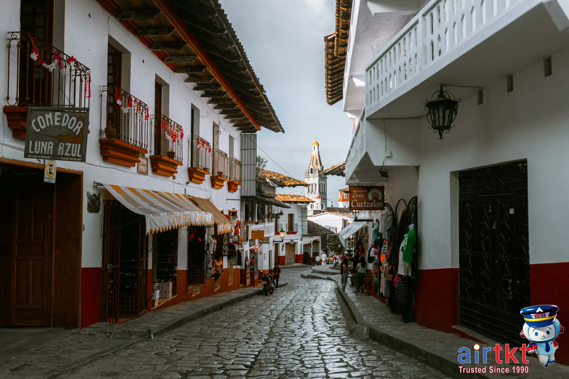 Historic cobblestone street with traditional Mexican architecture in a quaint village setting