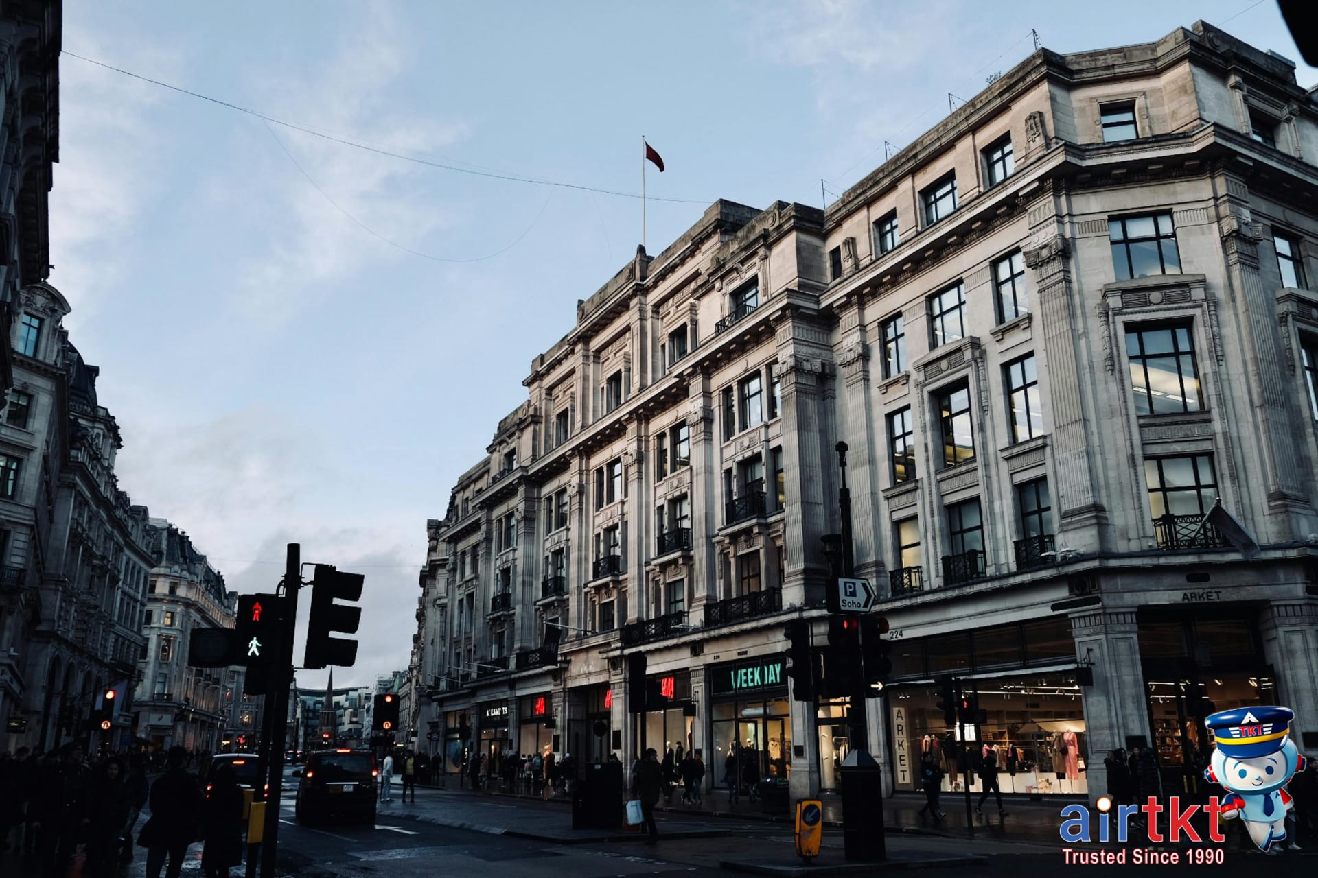 Street view of busy Oxford Street shopping district with London tourists