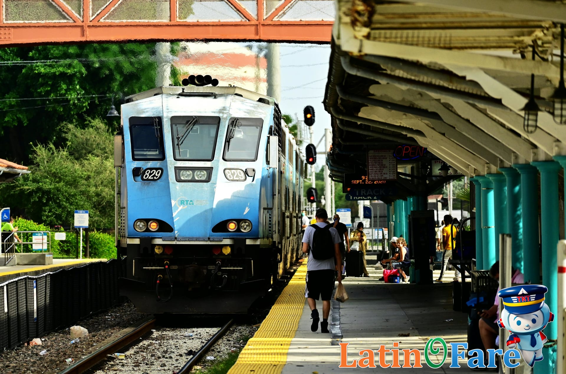 Miami Metrorail platform with commuters waiting for public transit connection across city lines