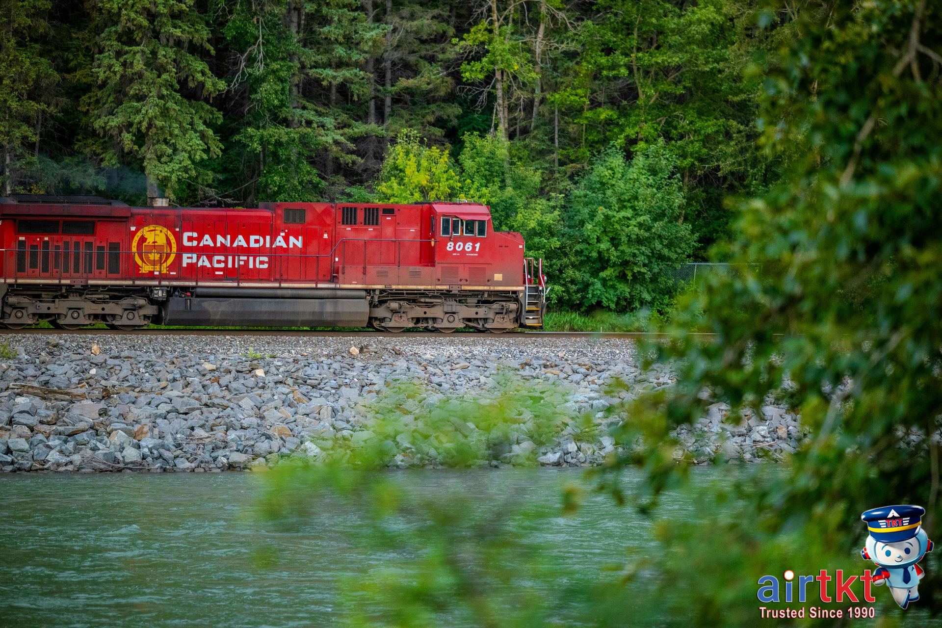 Affordable public transport option with Canadian Pacific train in lush landscape
