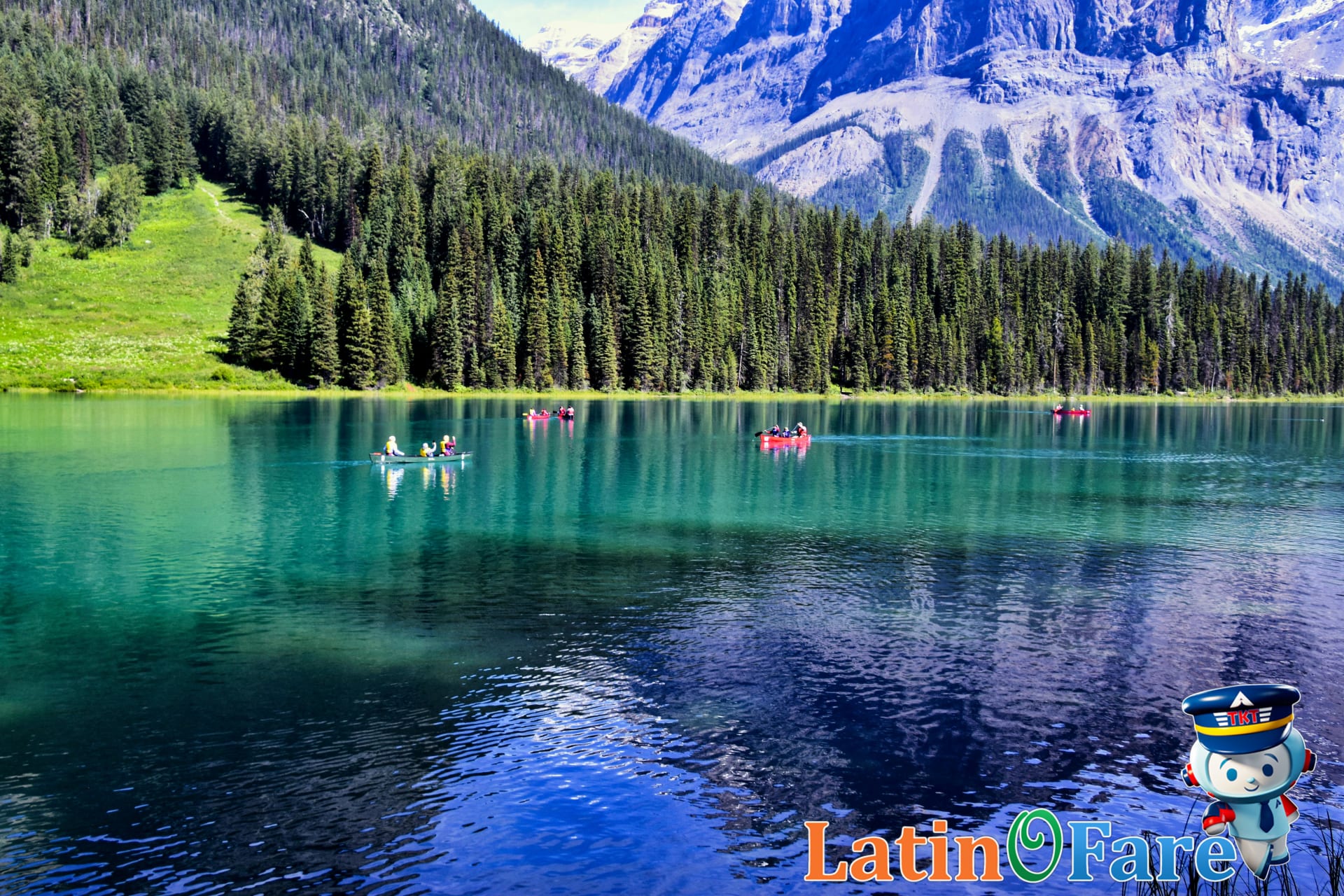 Canoes floating on crystal-clear Emerald Lake in Canadian Rockies hidden gem attractions.
