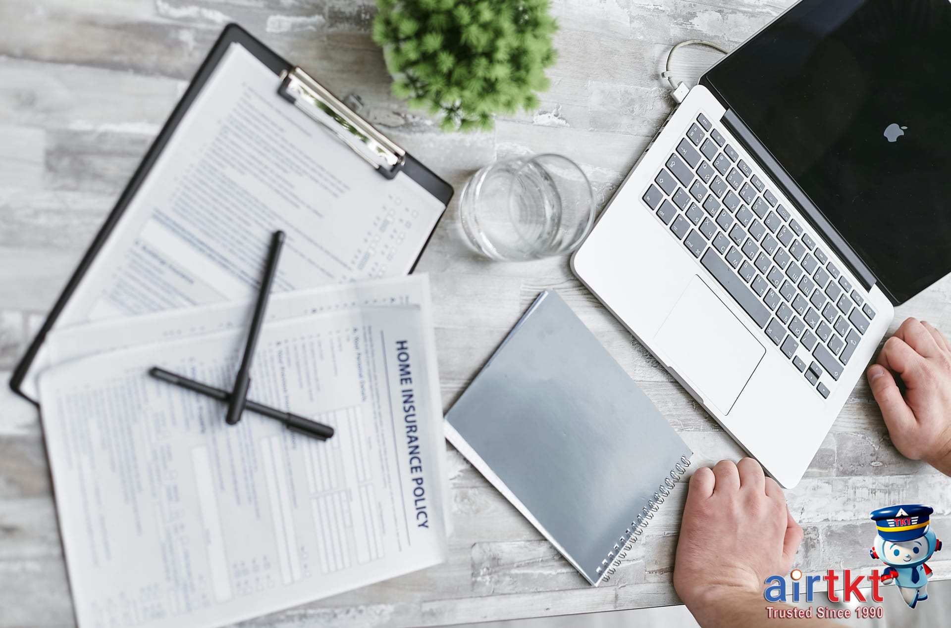 Essential travel insurance claim forms and pen on office desk