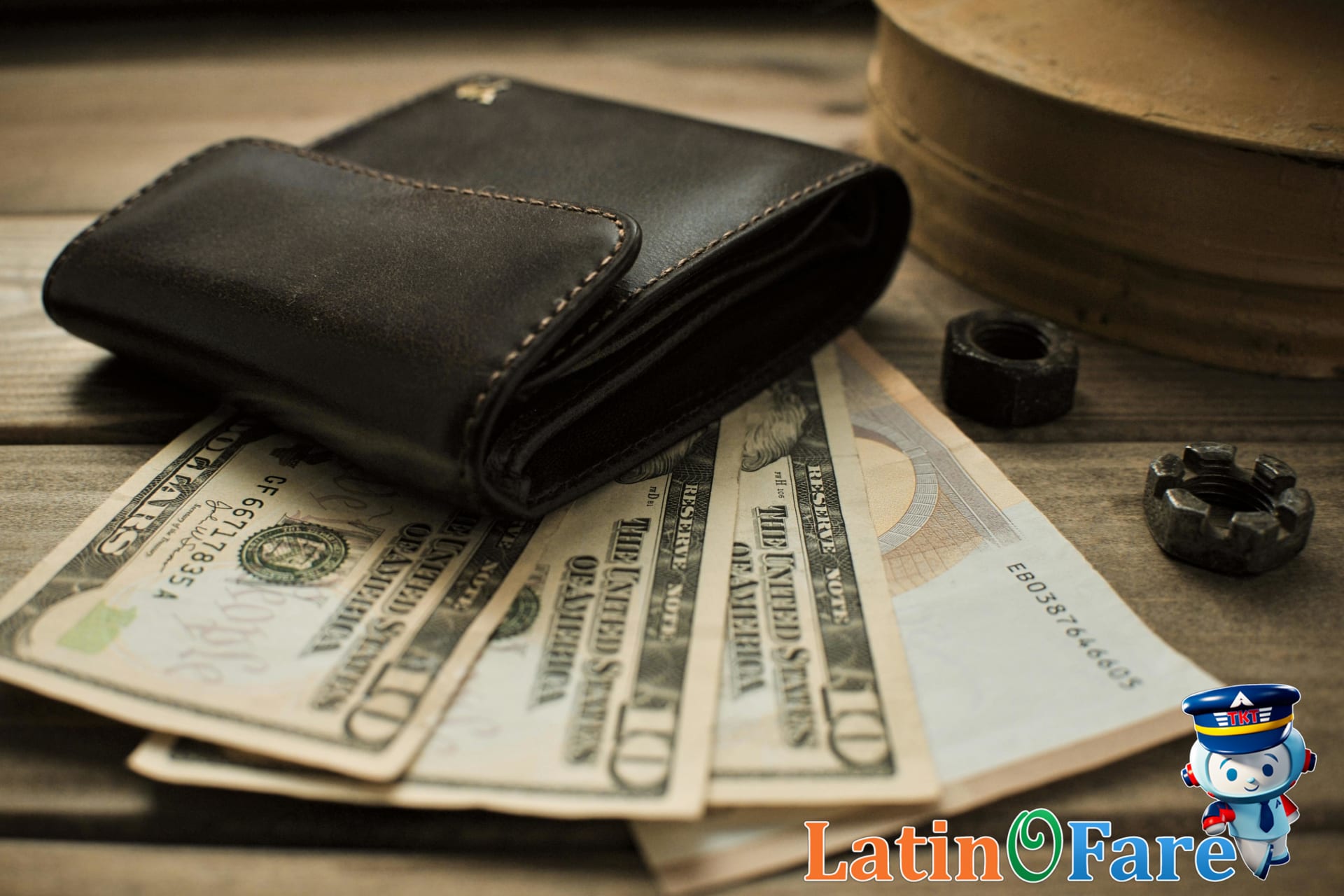 Close-up of three wallets on table showing different cash amounts for travel budget planning.