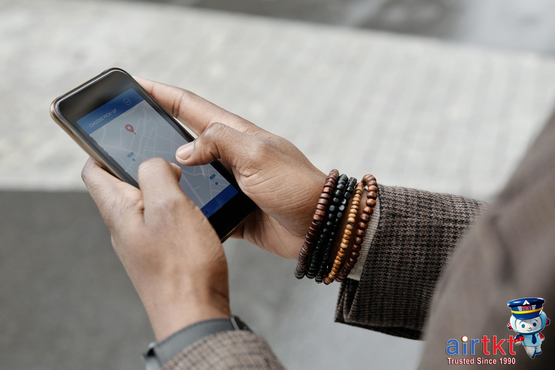 Traveler using AirTkt app on smartphone to find affordable flights with stopovers