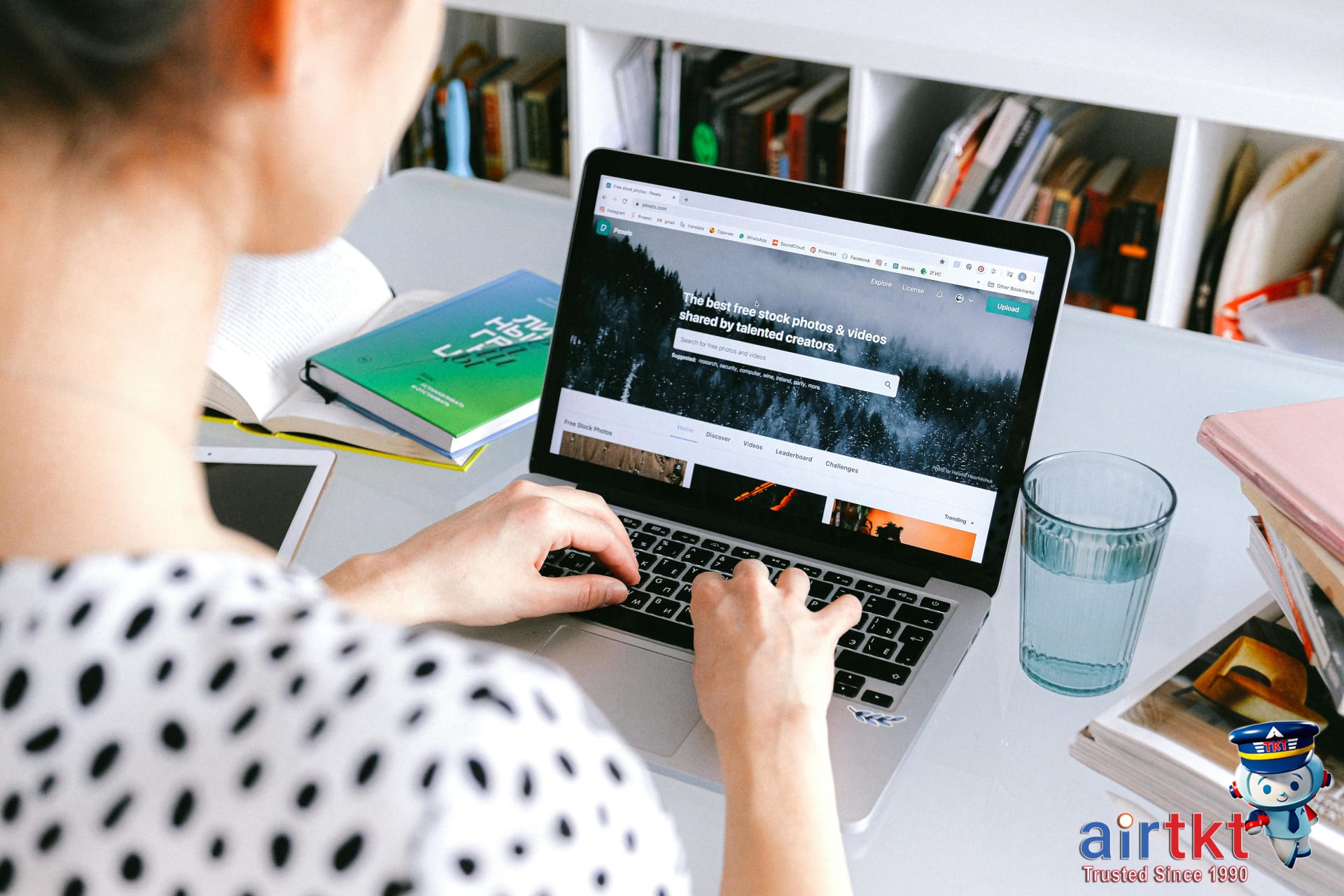 AirTkt online travel booking platform interface on laptop screen with search results displayed