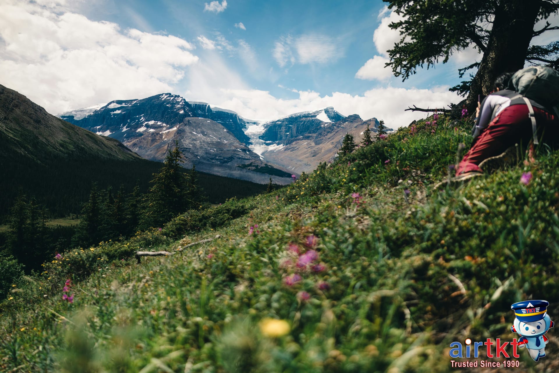 Hikers on Plain of Six Glaciers Trail in Canadian Rockies, surrounded by mountain scenery