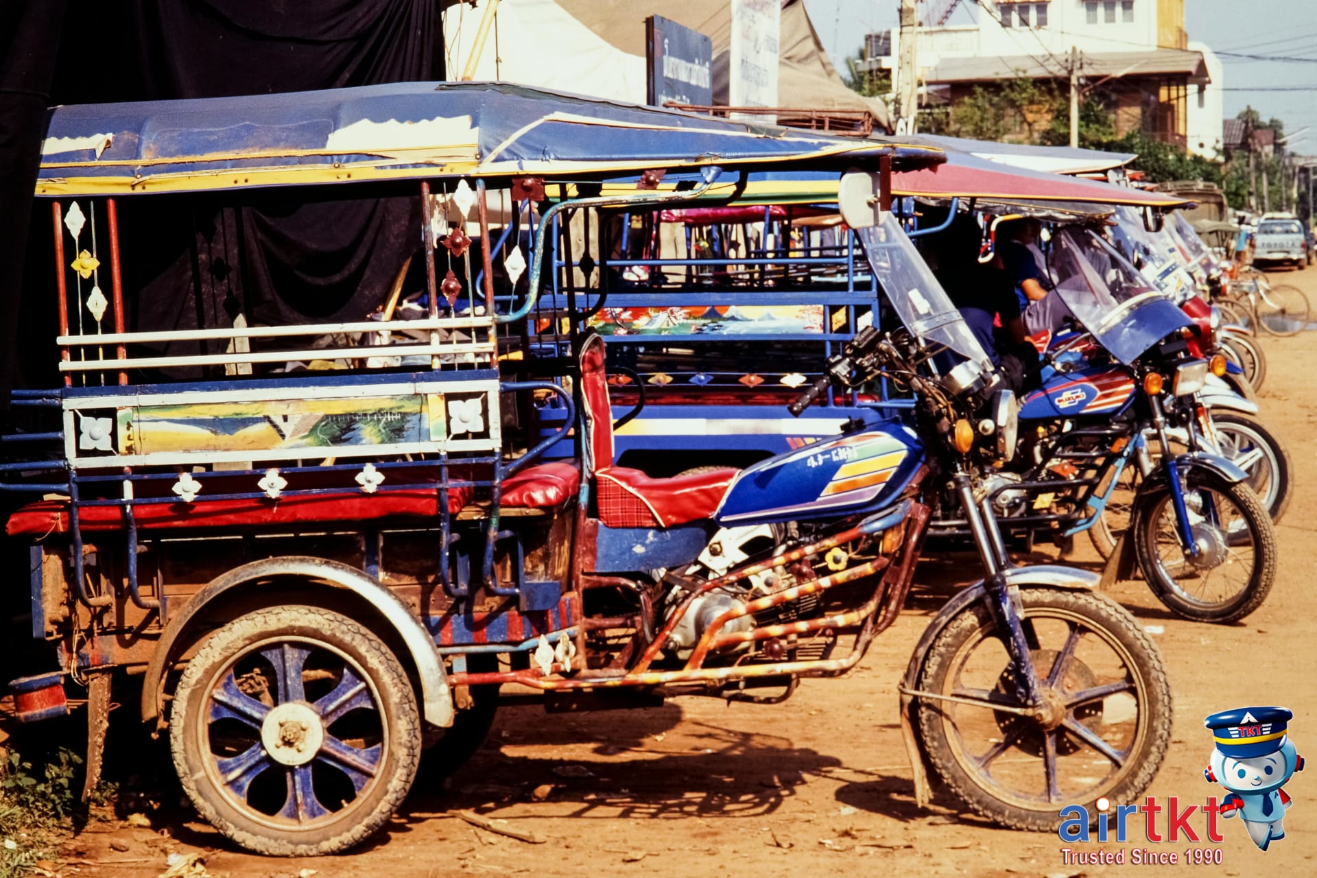 Chiang Mai local songthaew vehicles parked on a busy street