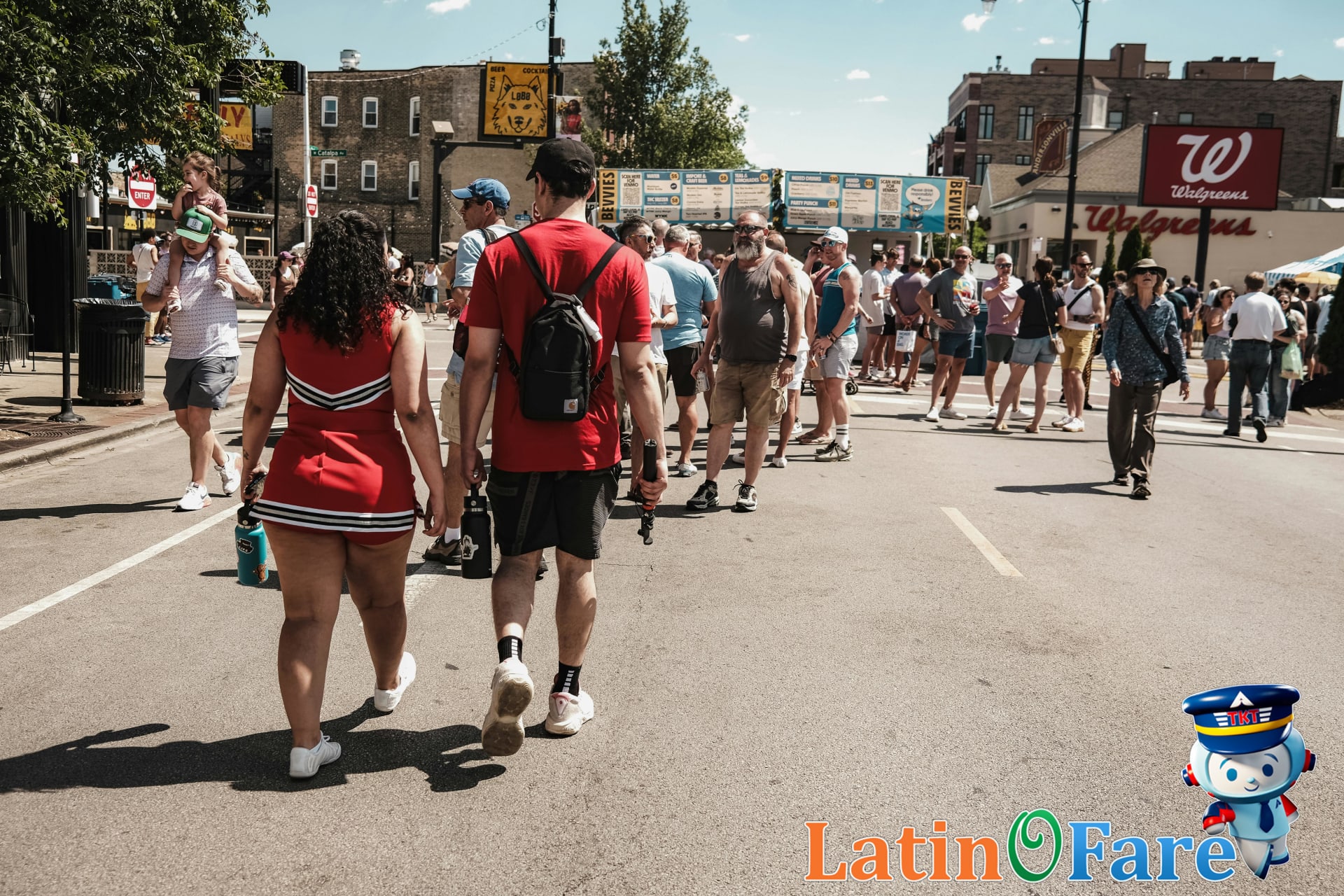 People enjoying Lollapalooza in Chicago under sunny skies with city skyline in background