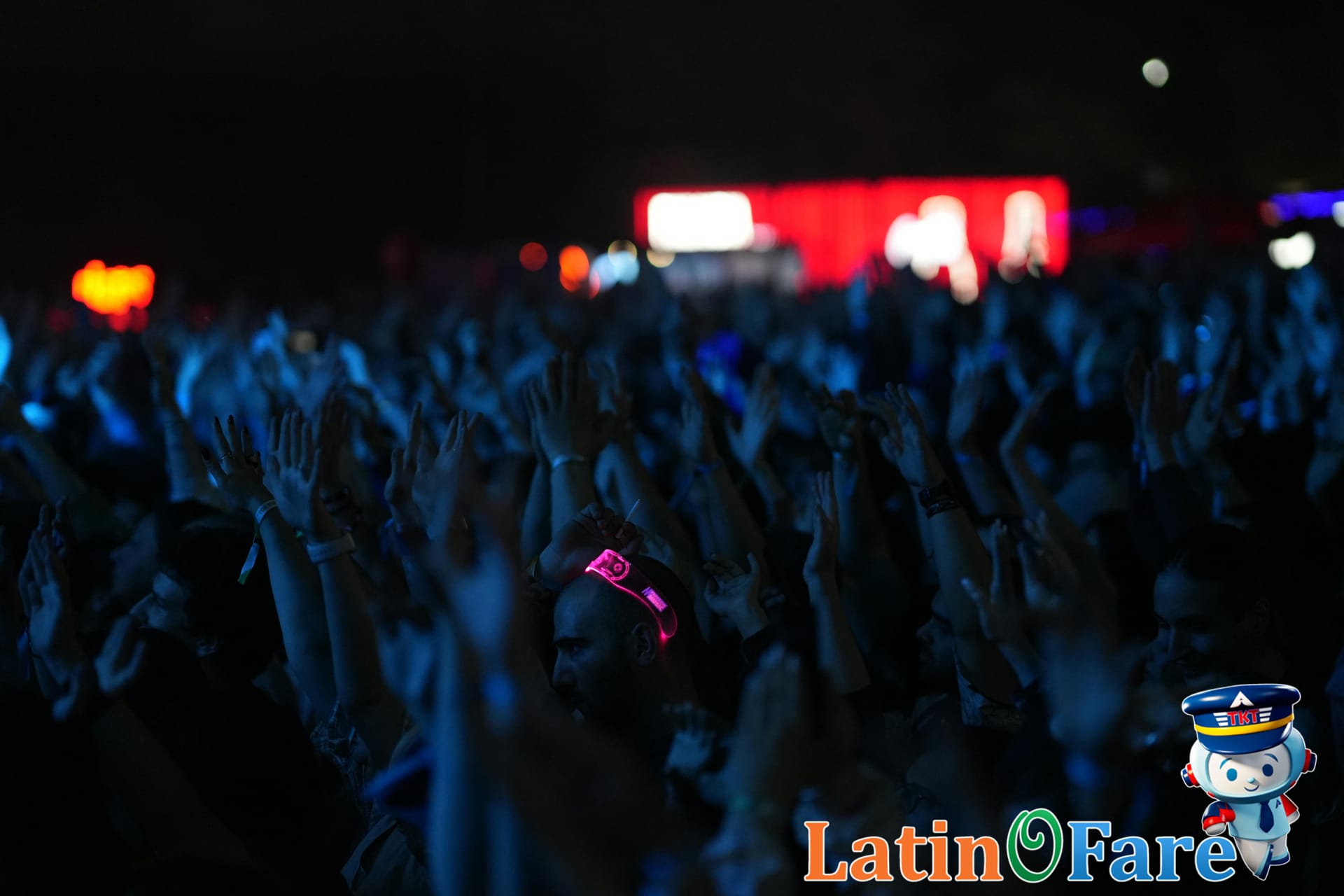 Dynamic nighttime concert at Lollapalooza Chicago festival with bright lights and large crowd.