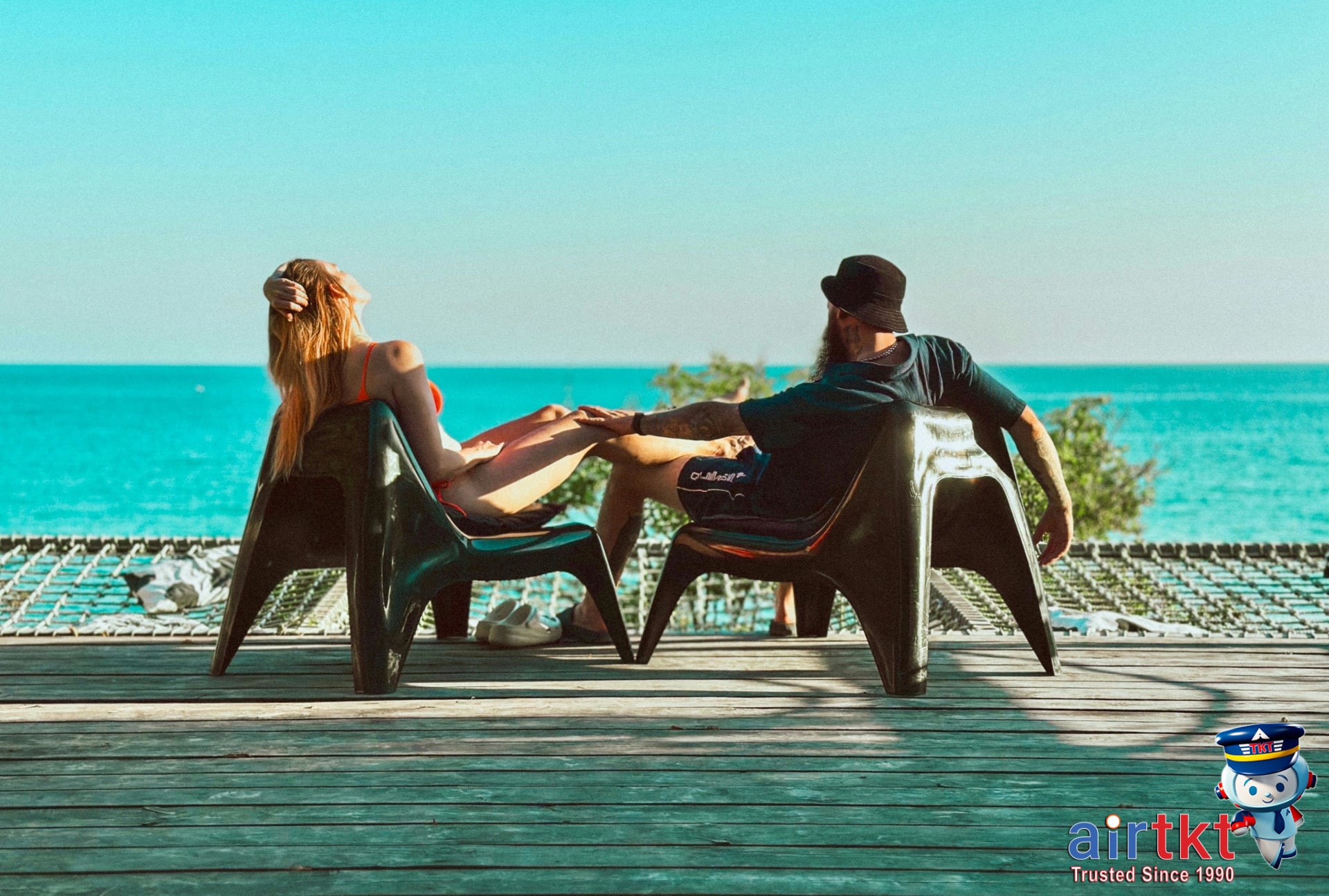 Benefits of shoulder season travel with couple enjoying empty sunny beach