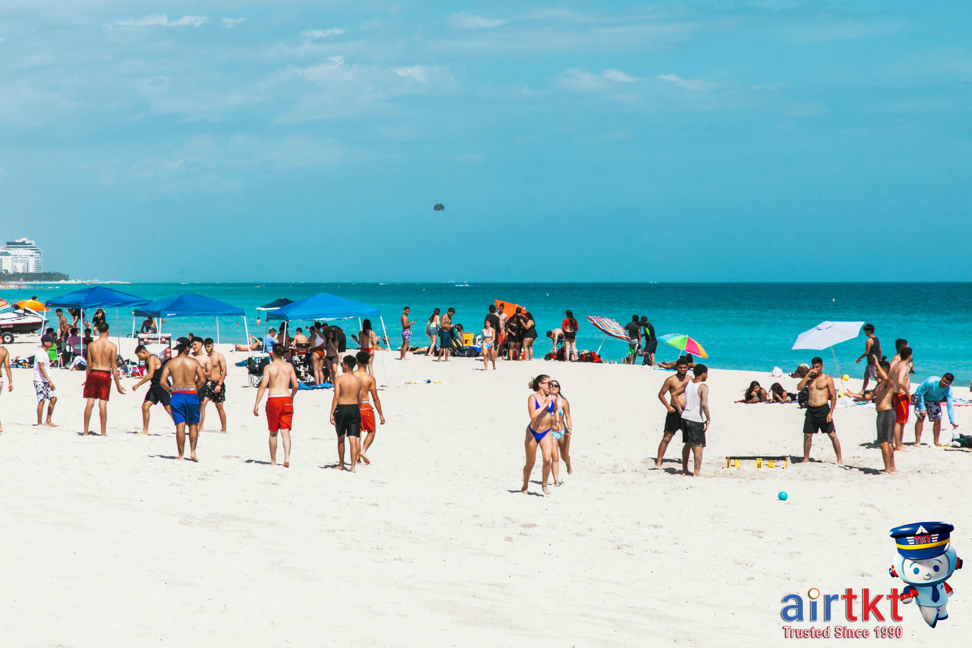People enjoying Miami beaches and water sports with sunshine and blue water
