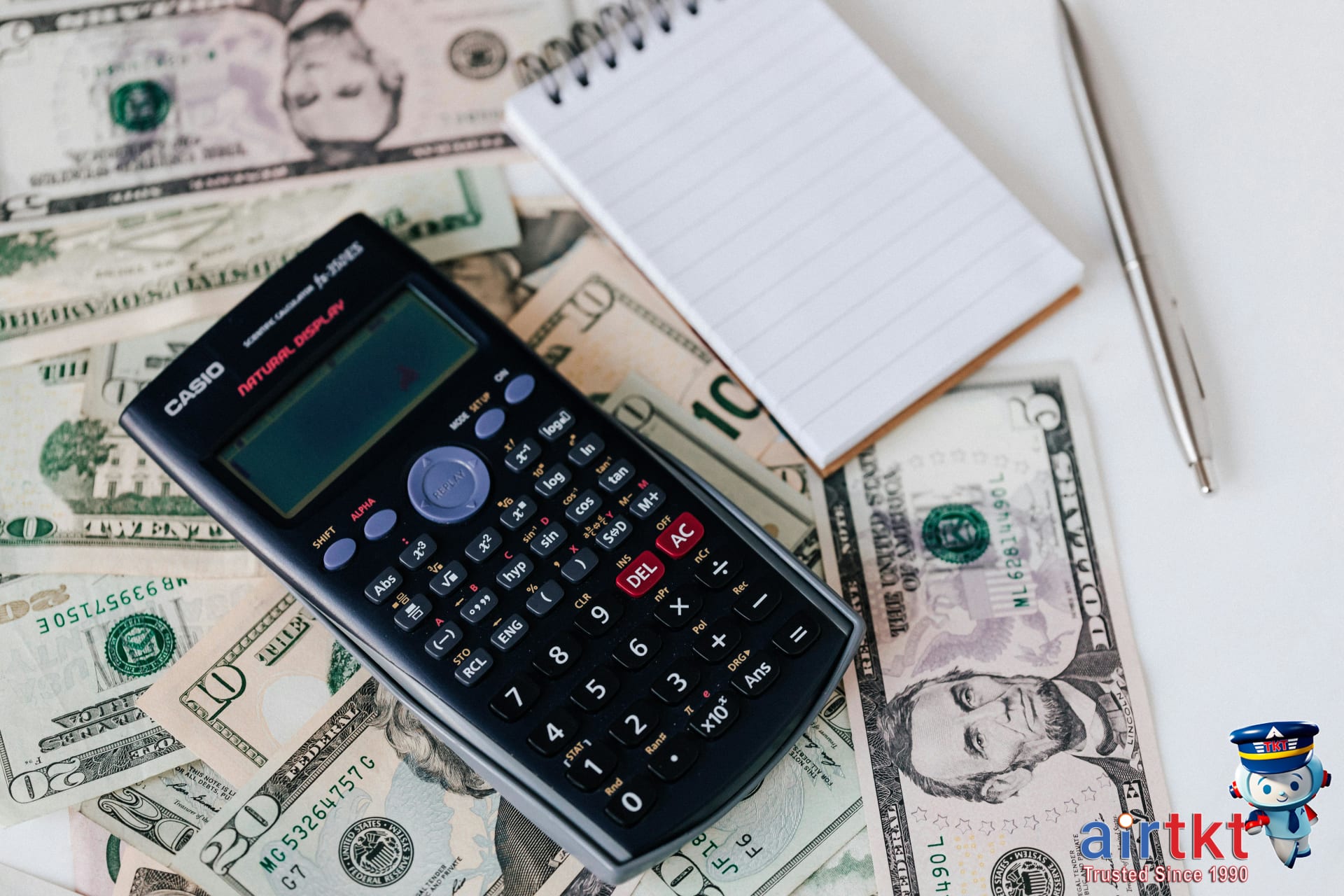 Traveler planning budget for Rio Carnival trip using calculator and tickets